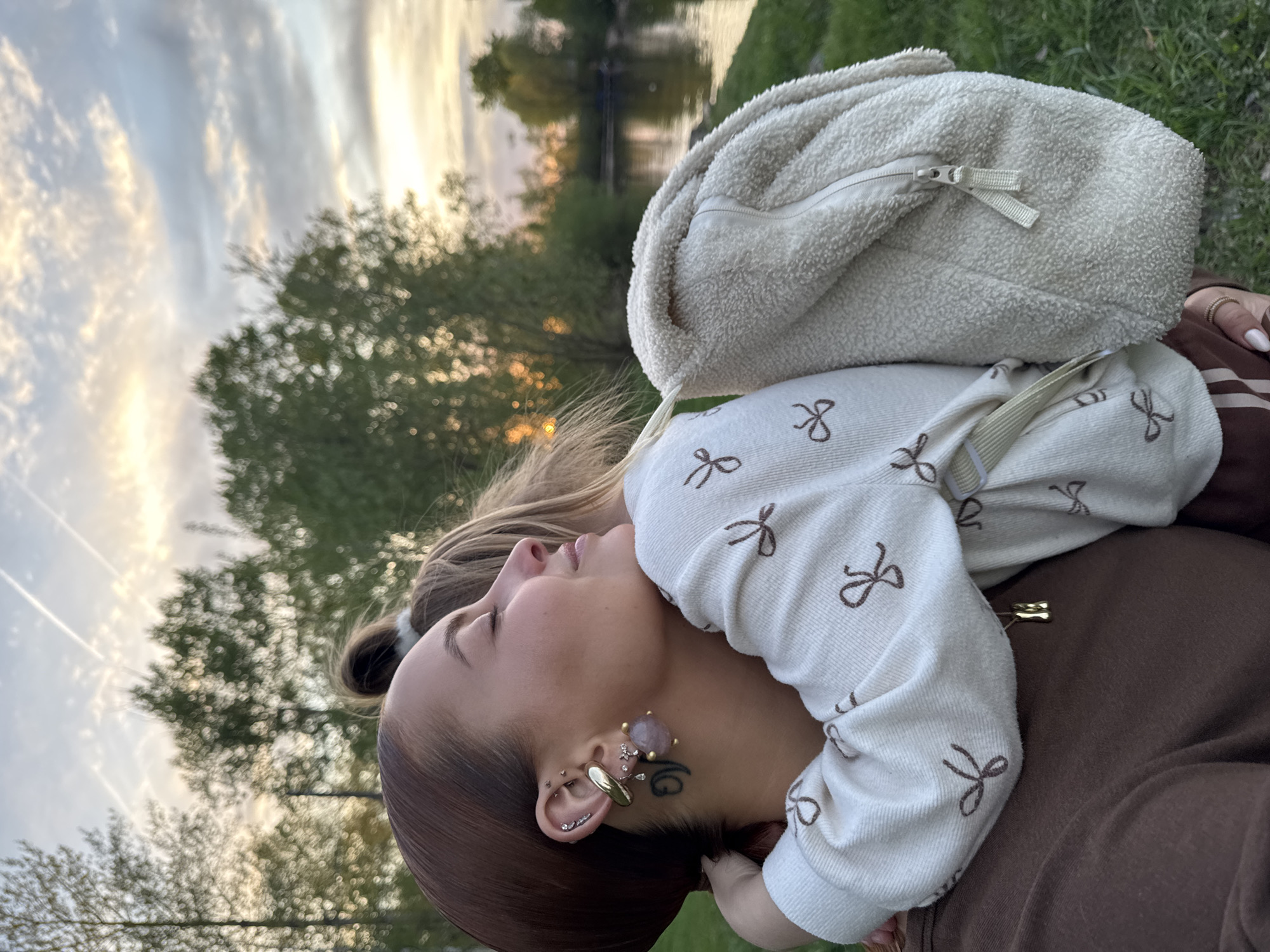 Family enjoys sunset by Kama River in Chaikovsky