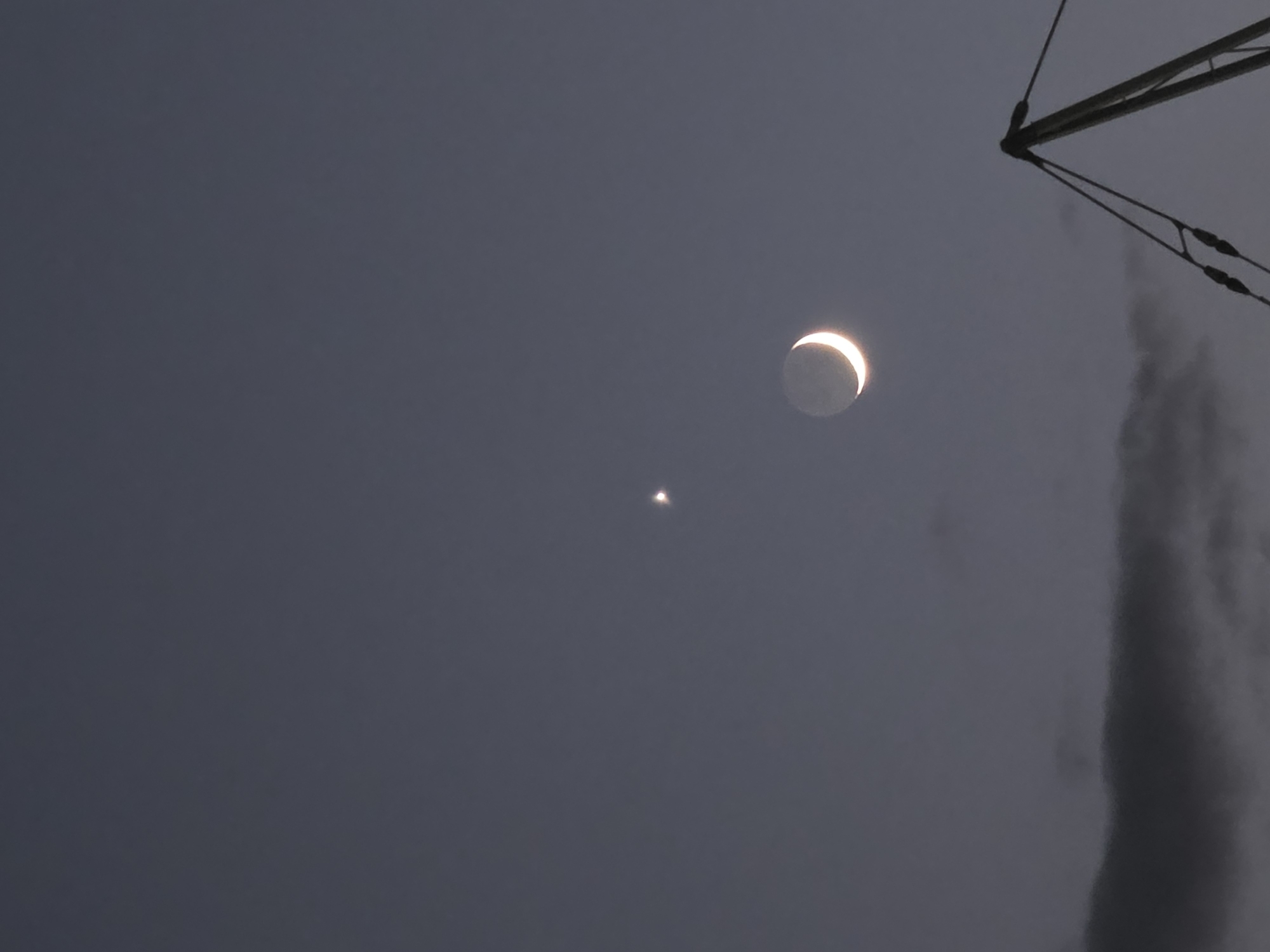 Crescent moon and star at dusk over Podgorica