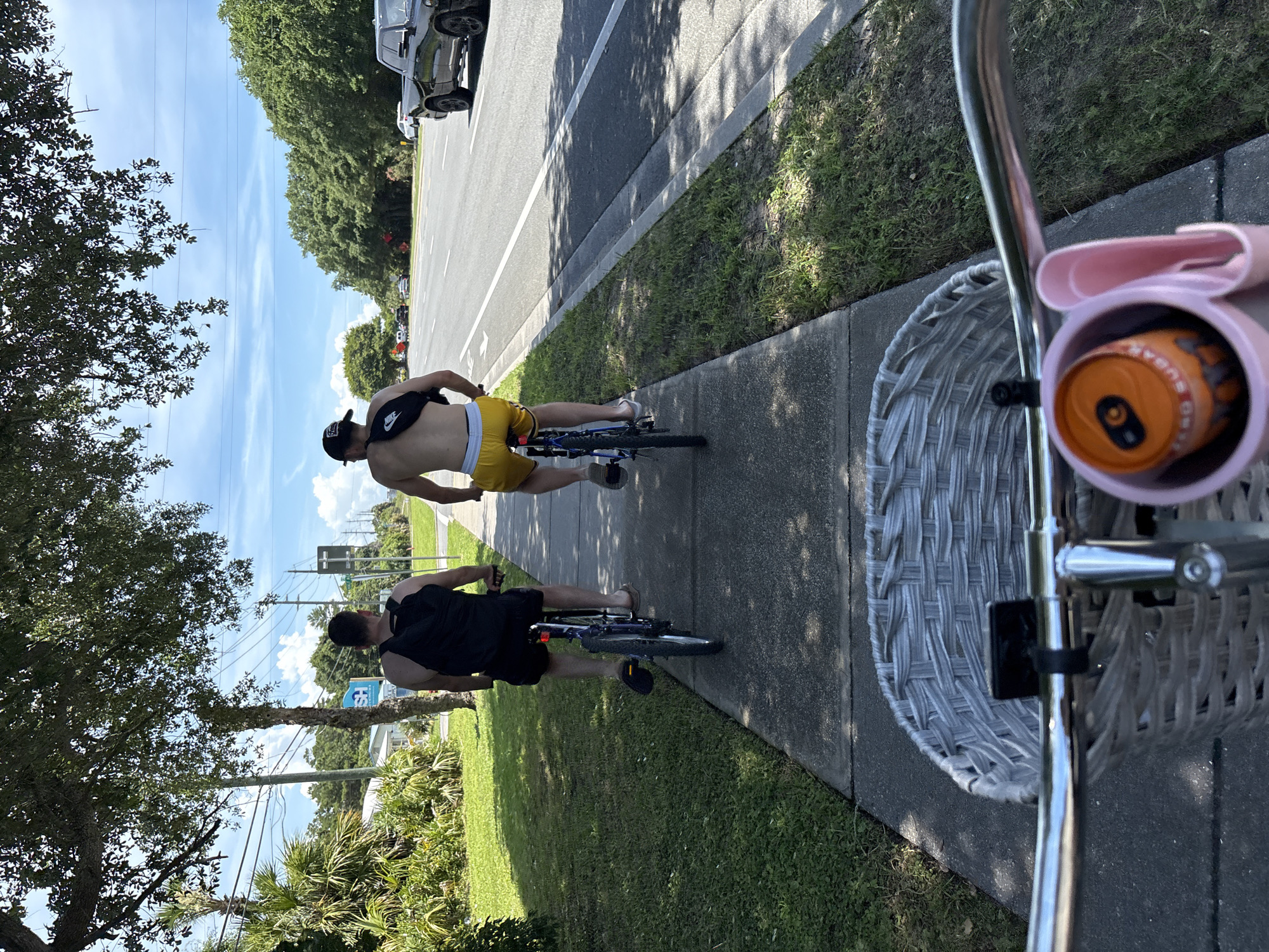 Two men cycle with Monster Energy drinks in Panama City Beach