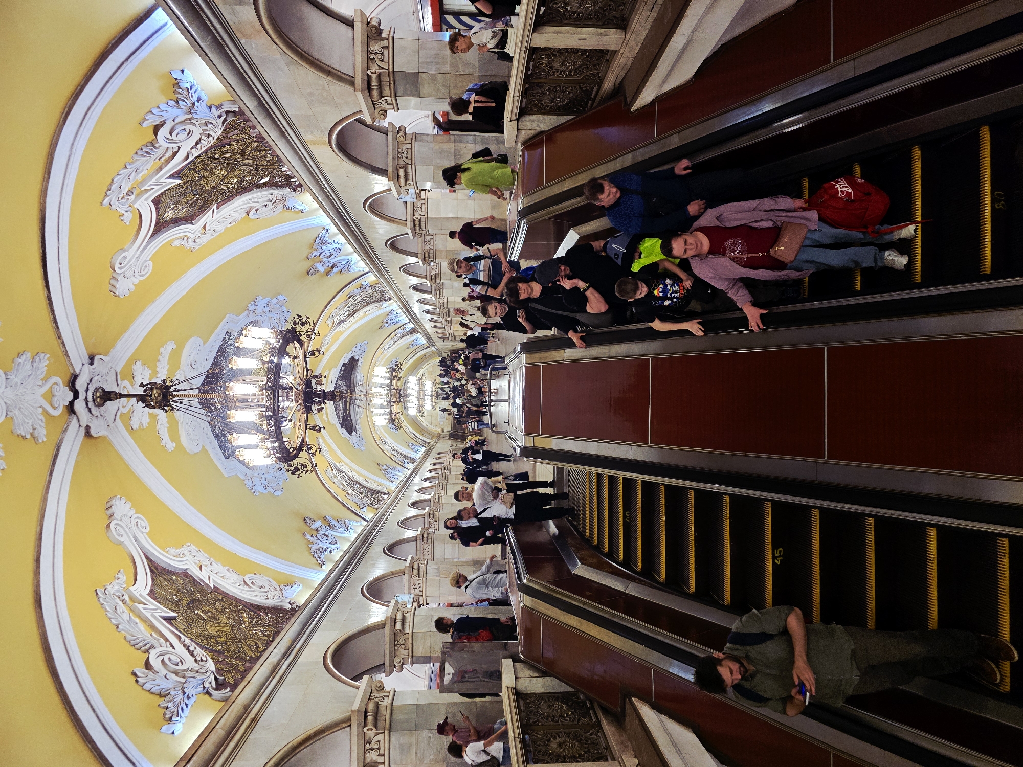 Moscow Metro Commuters Navigate Ornate Komsomolskaya Station Escalators