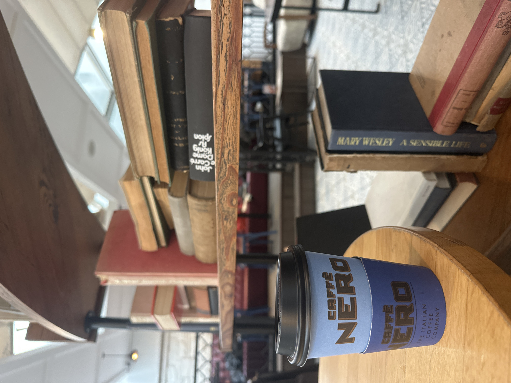 Coffee and books moment captured in Bodrum cafe setting