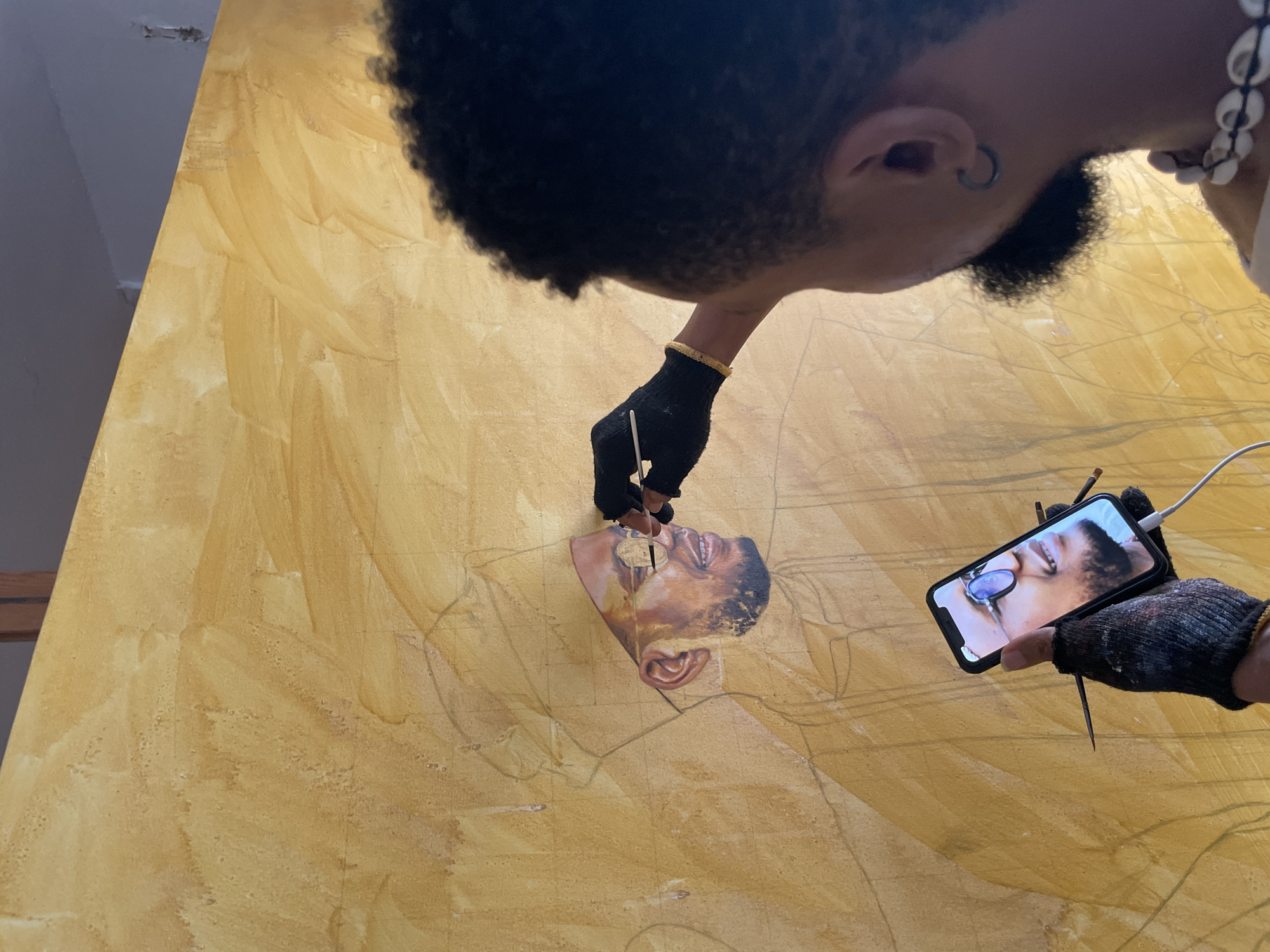 Artist documents painting session in Ado, Nigeria studio