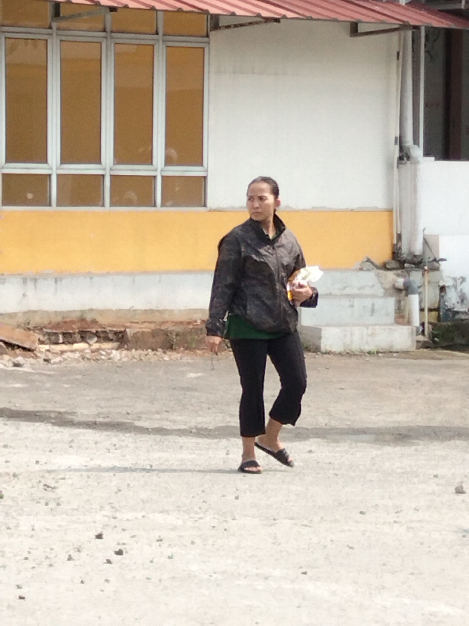 Morning street activity outside a South Tangerang commercial building