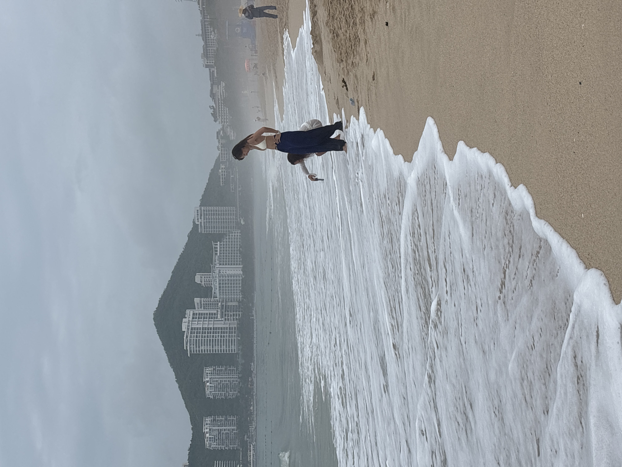 Waves, red lanterns, and beachside activity in Jiyang District