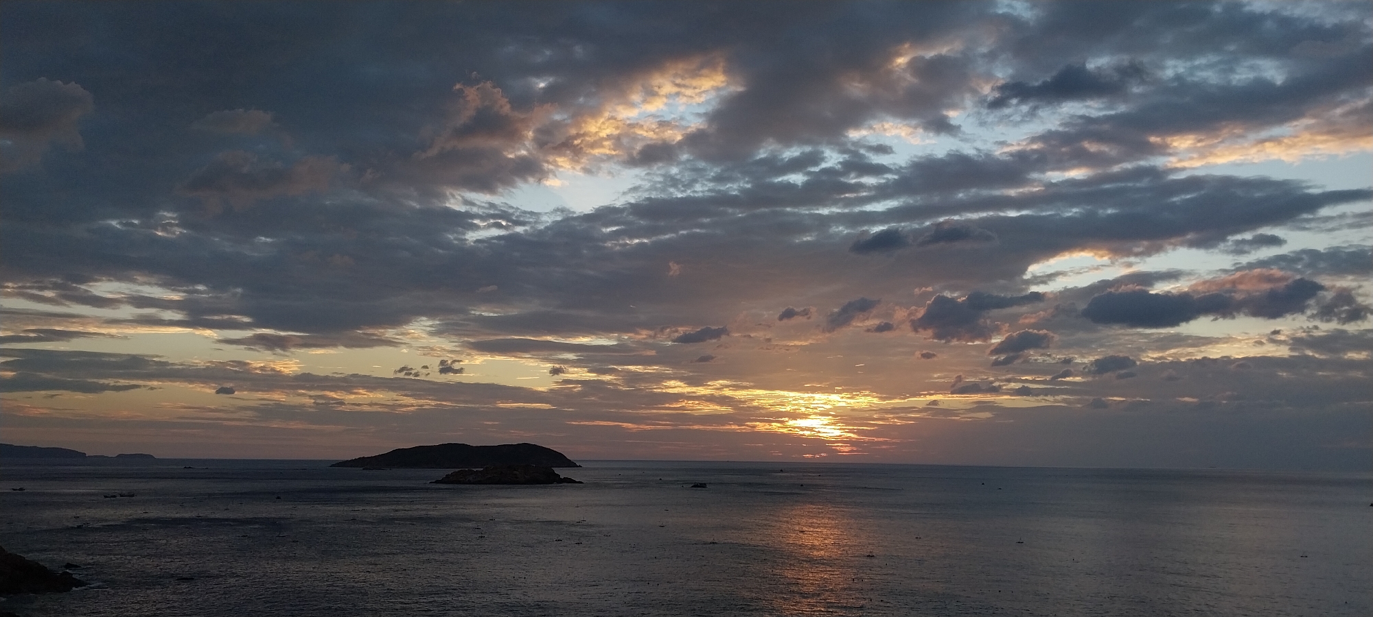 Ocean sunset captured from multiple angles, clouds and golden light.