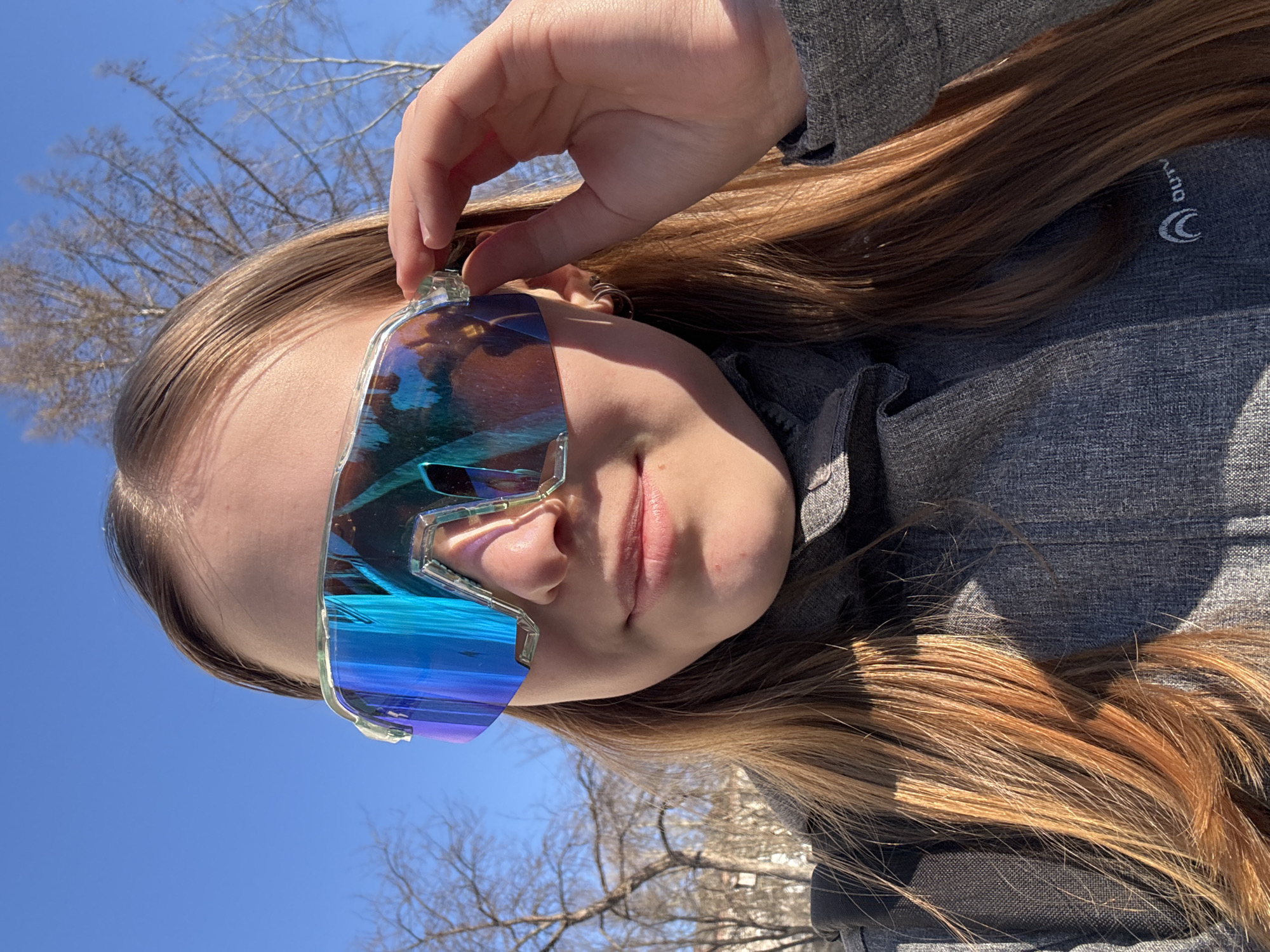 Person poses with futuristic sunglasses in early morning Berezniki