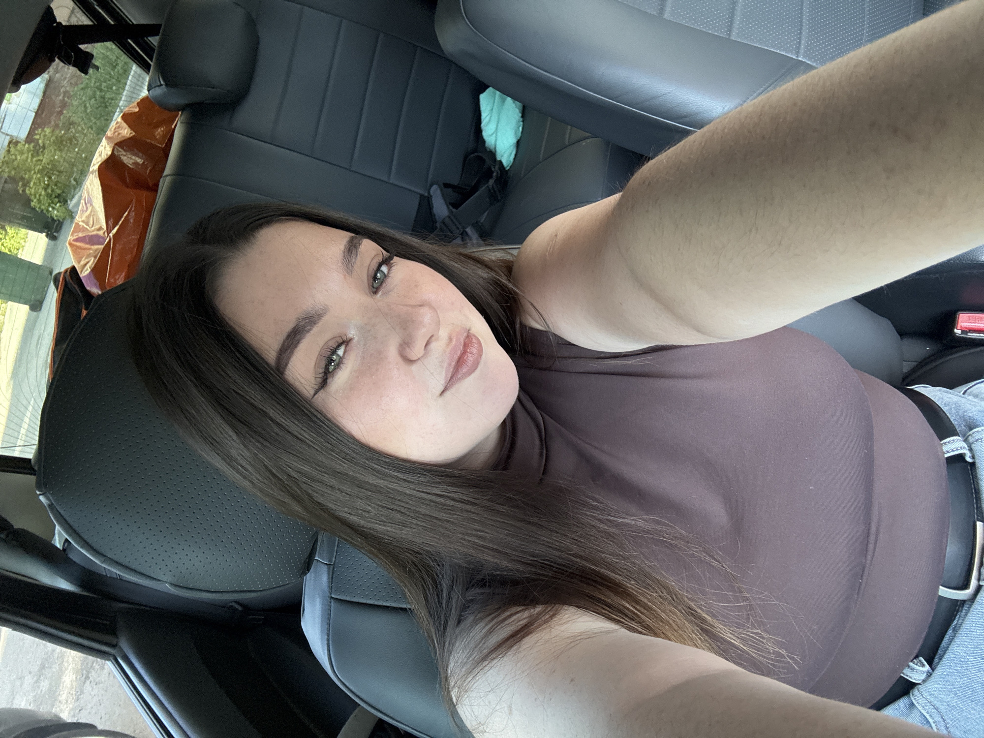 Woman takes selfie in car driver's seat in Perm