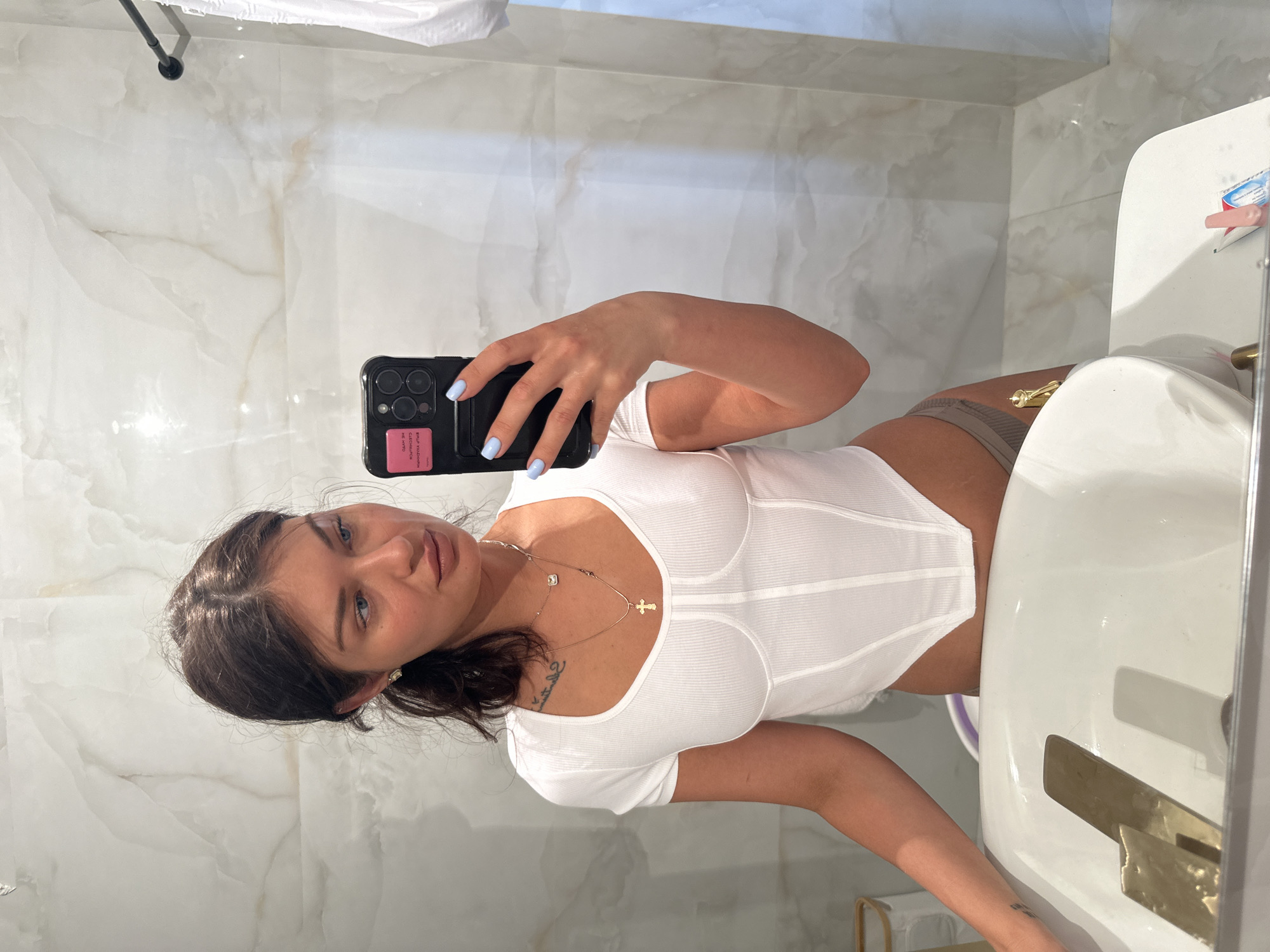 Woman takes mirror selfie in Gavrilkovo bathroom