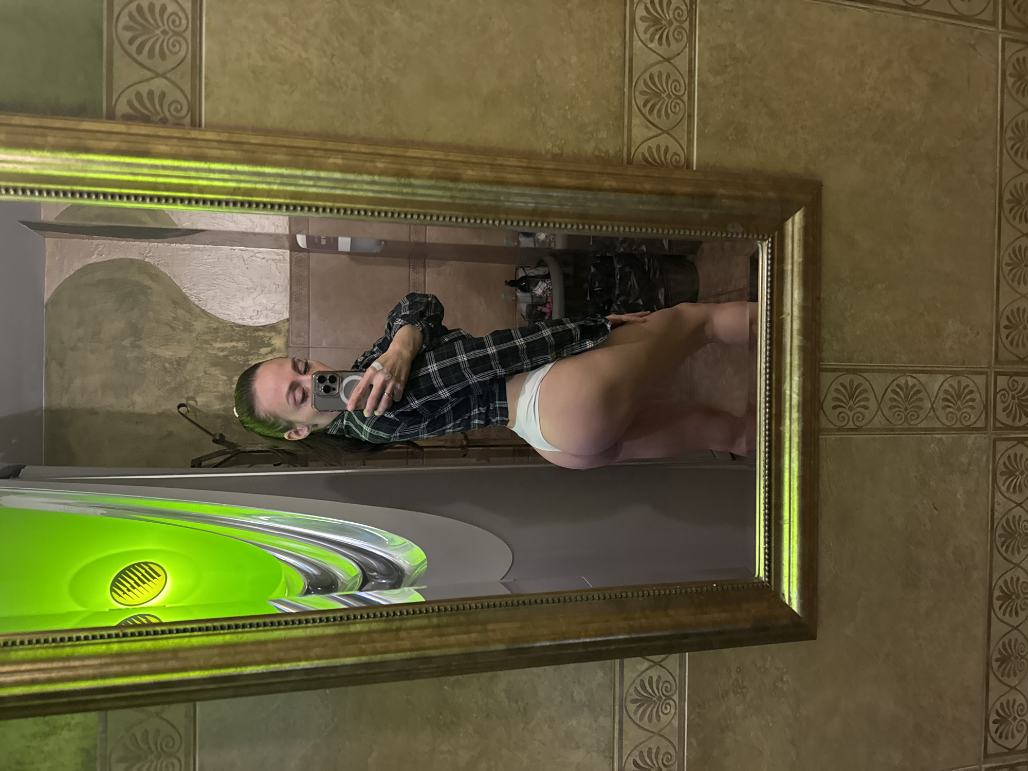 Woman takes mirror selfie in ornate frame, Saint Petersburg