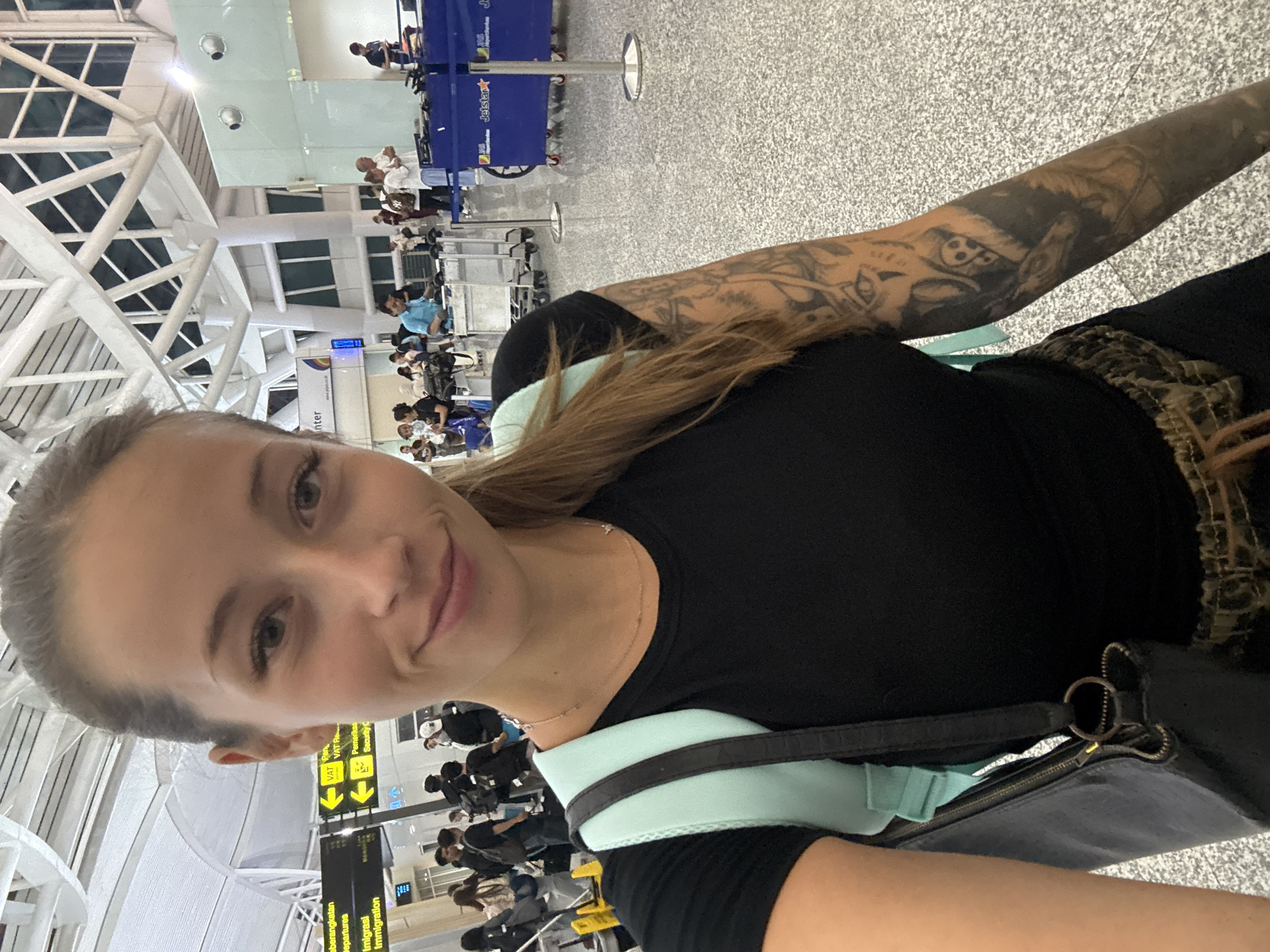 Travelers move through Kuta airport during routine operations