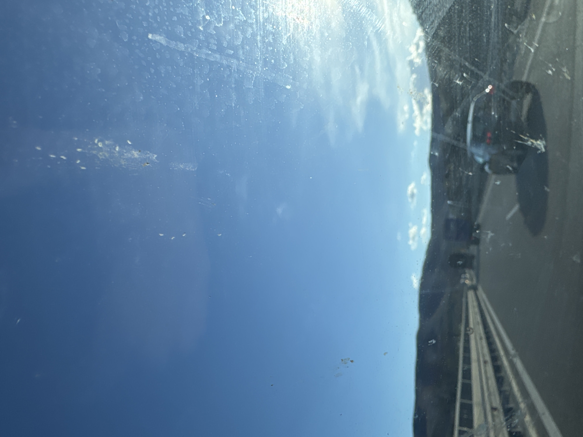 Car window view captures blue sky, highway in Bulgaria