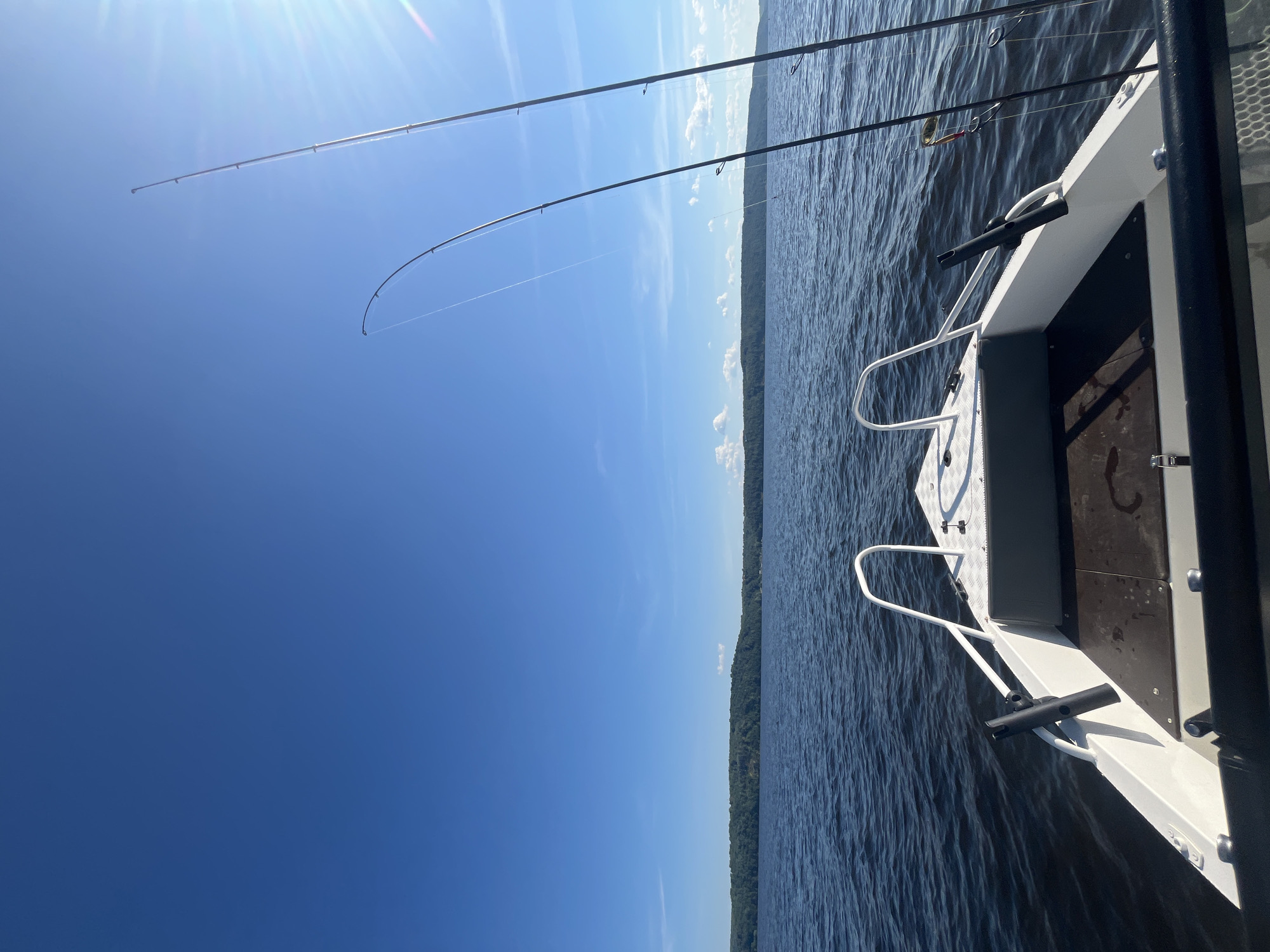 Fishing boat out on sunny Russian lake waters at midday