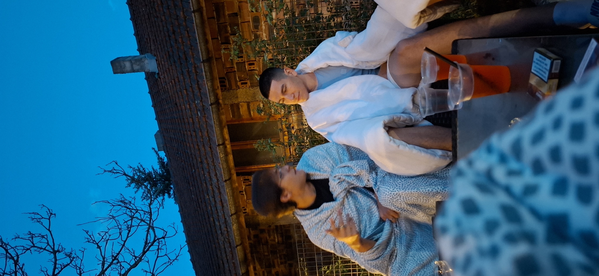 Laid-back evening hangout in rural Lobosh, blankets and bathrobes out.
