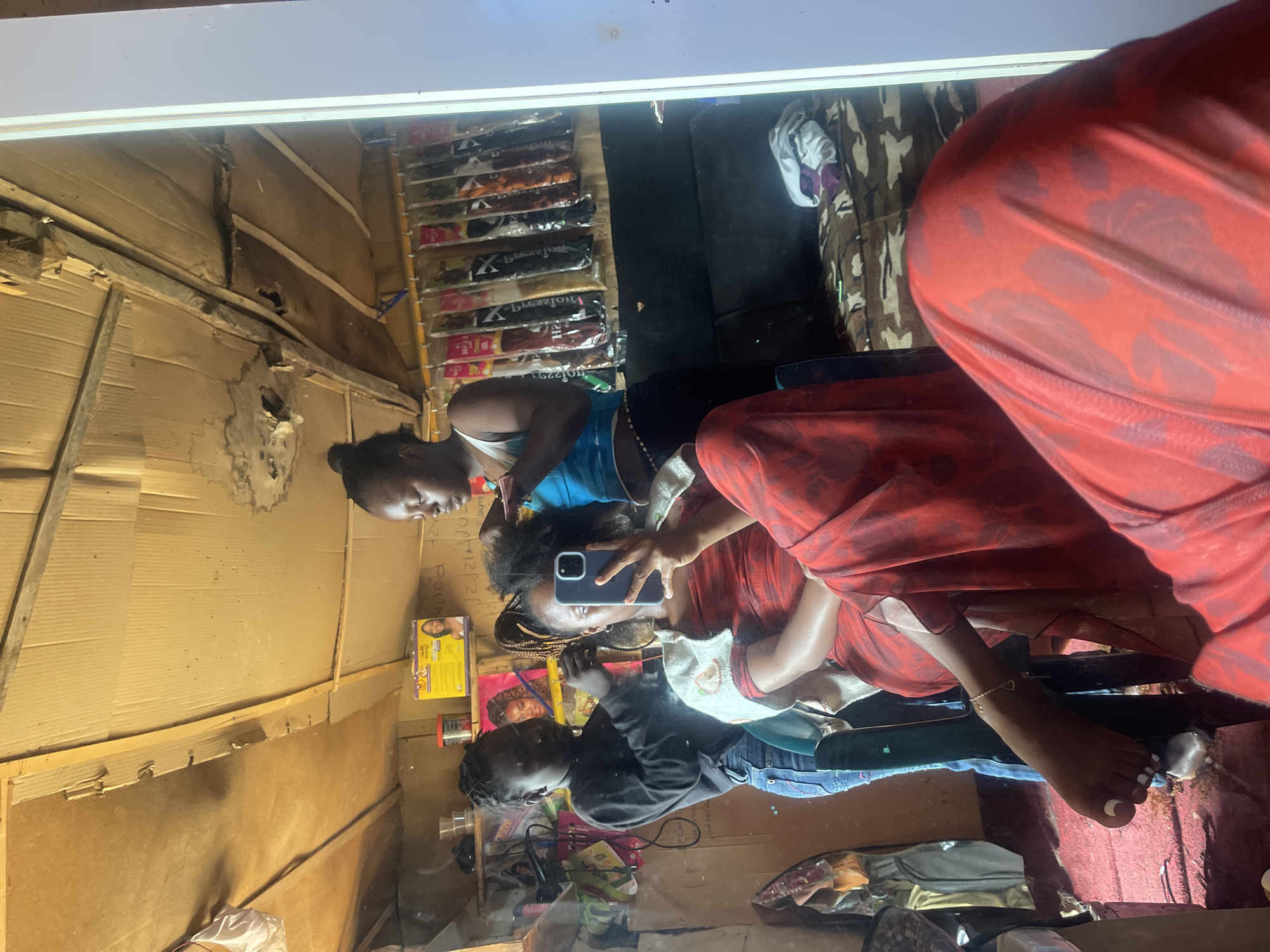 Hair salon session in Jos, caught in the mirror