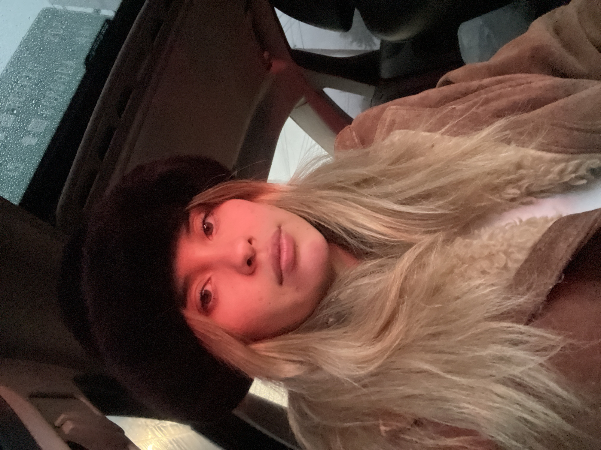 Woman takes selfies in car during rain in Argentina