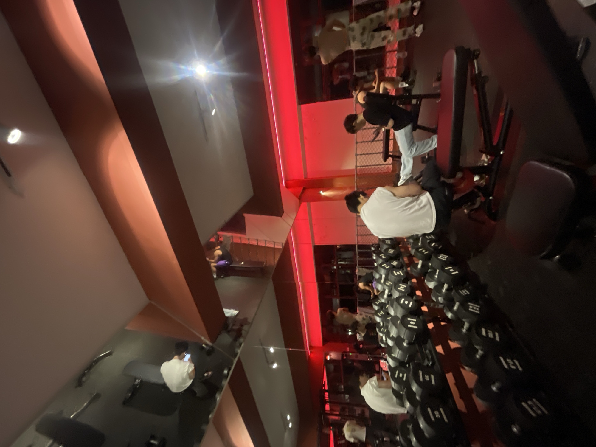 Young men exercise at red-lit gym in Chongqing tech zone