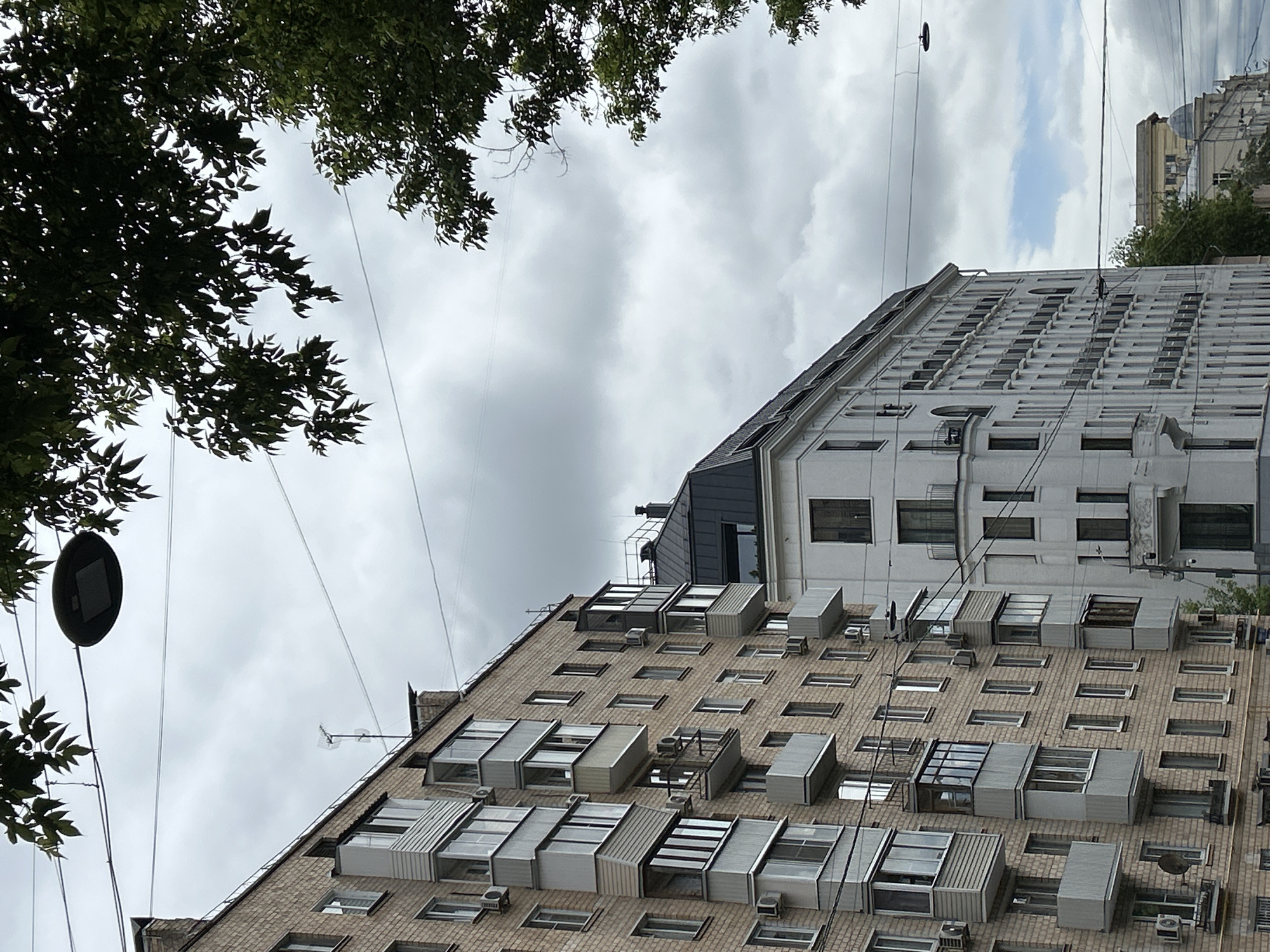Urban observer captures upward view of brick building architecture
