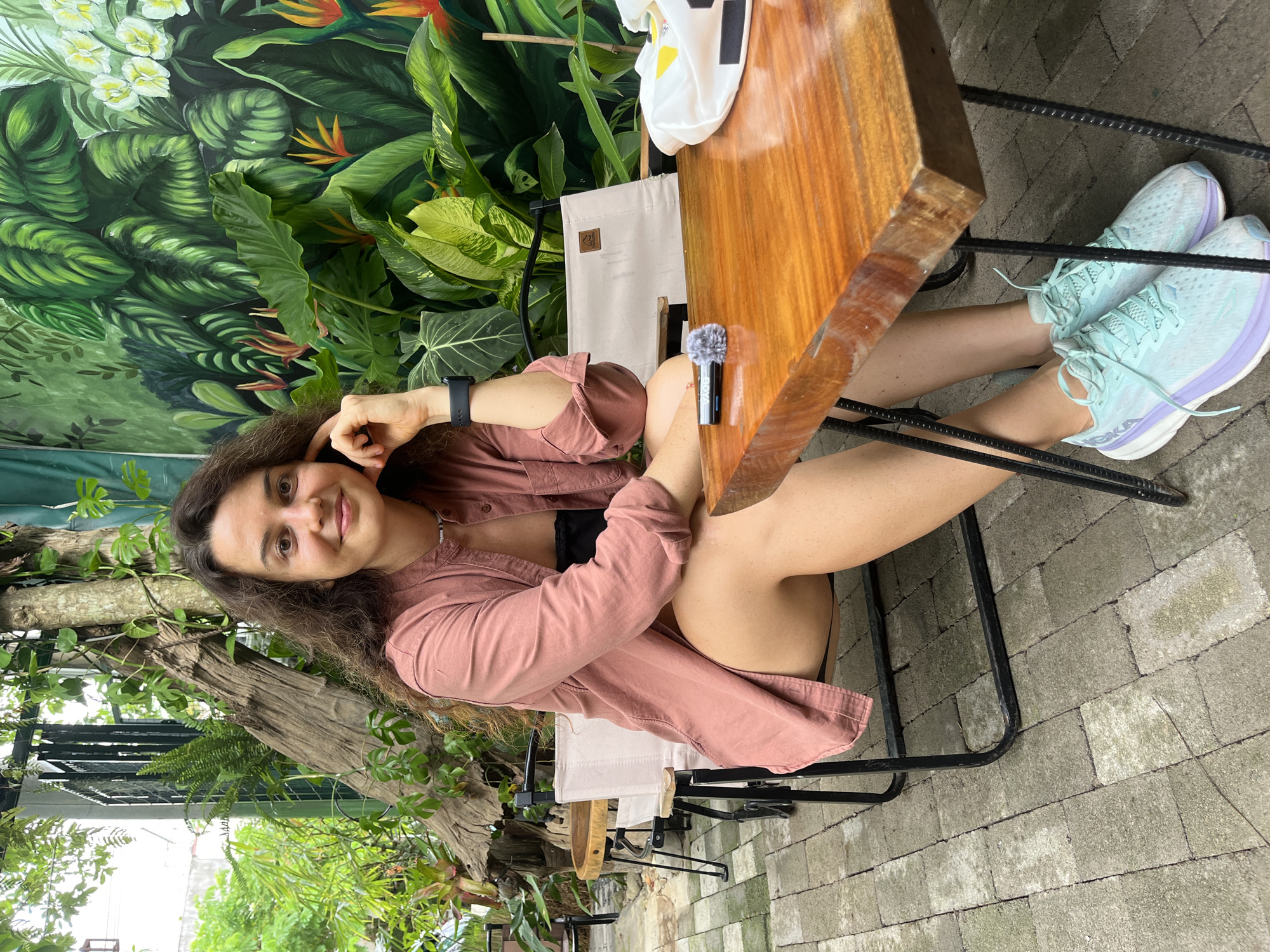 Relaxed morning at a mural-backed outdoor café in Phu Thuy Ward