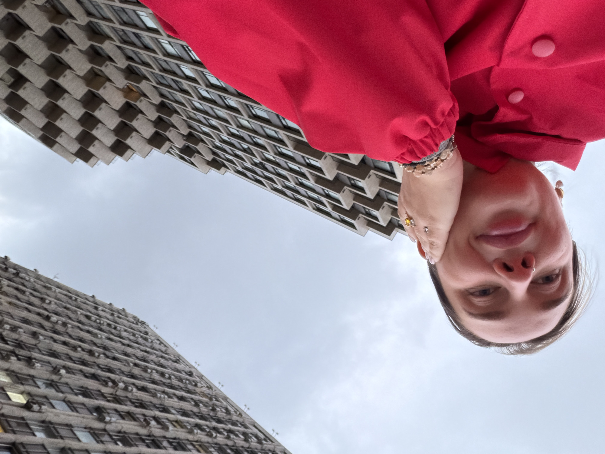 Rotated street photography captures person between Moscow buildings
