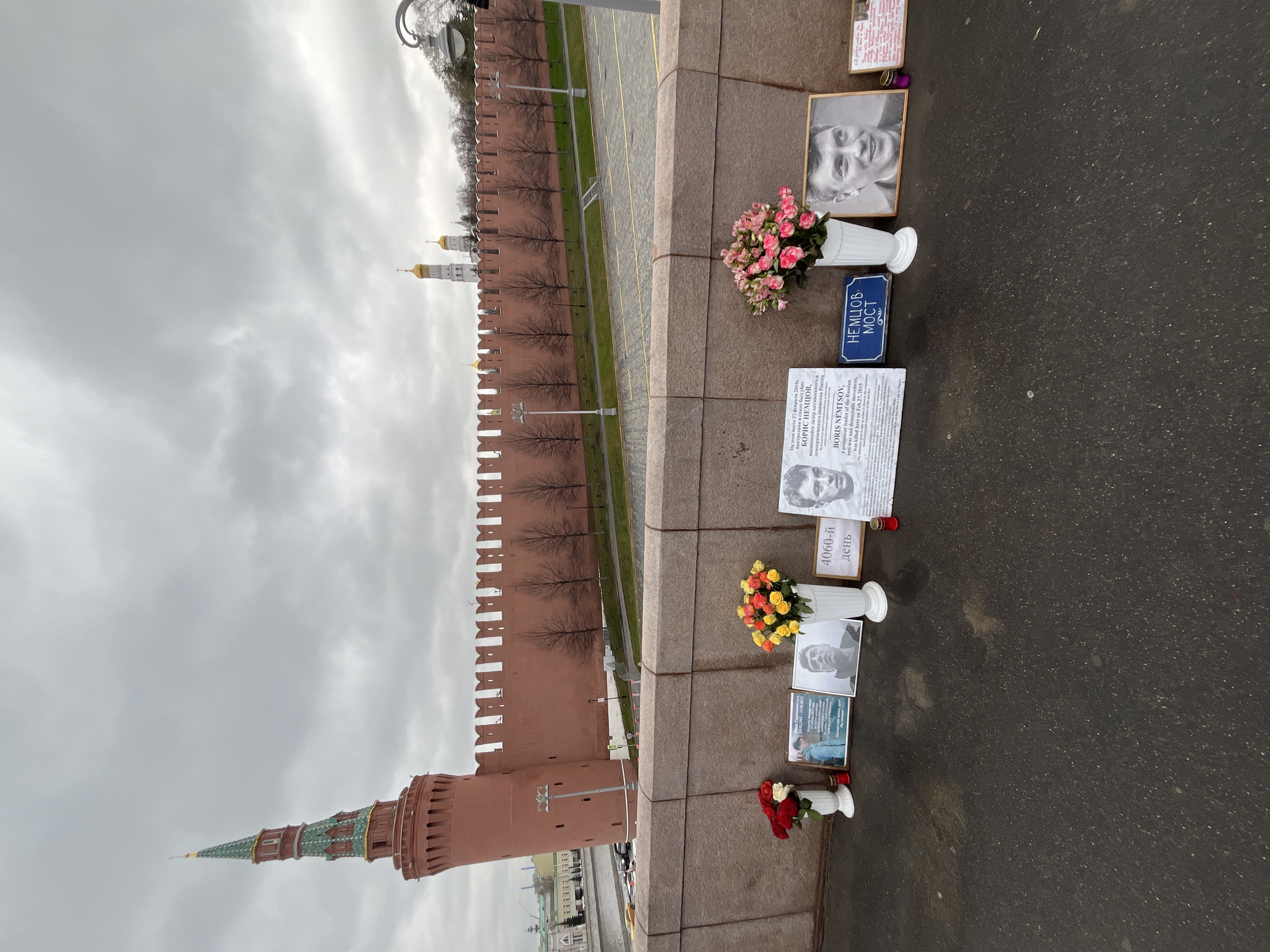 Man in orange tracksuit lies on Red Square cobblestones