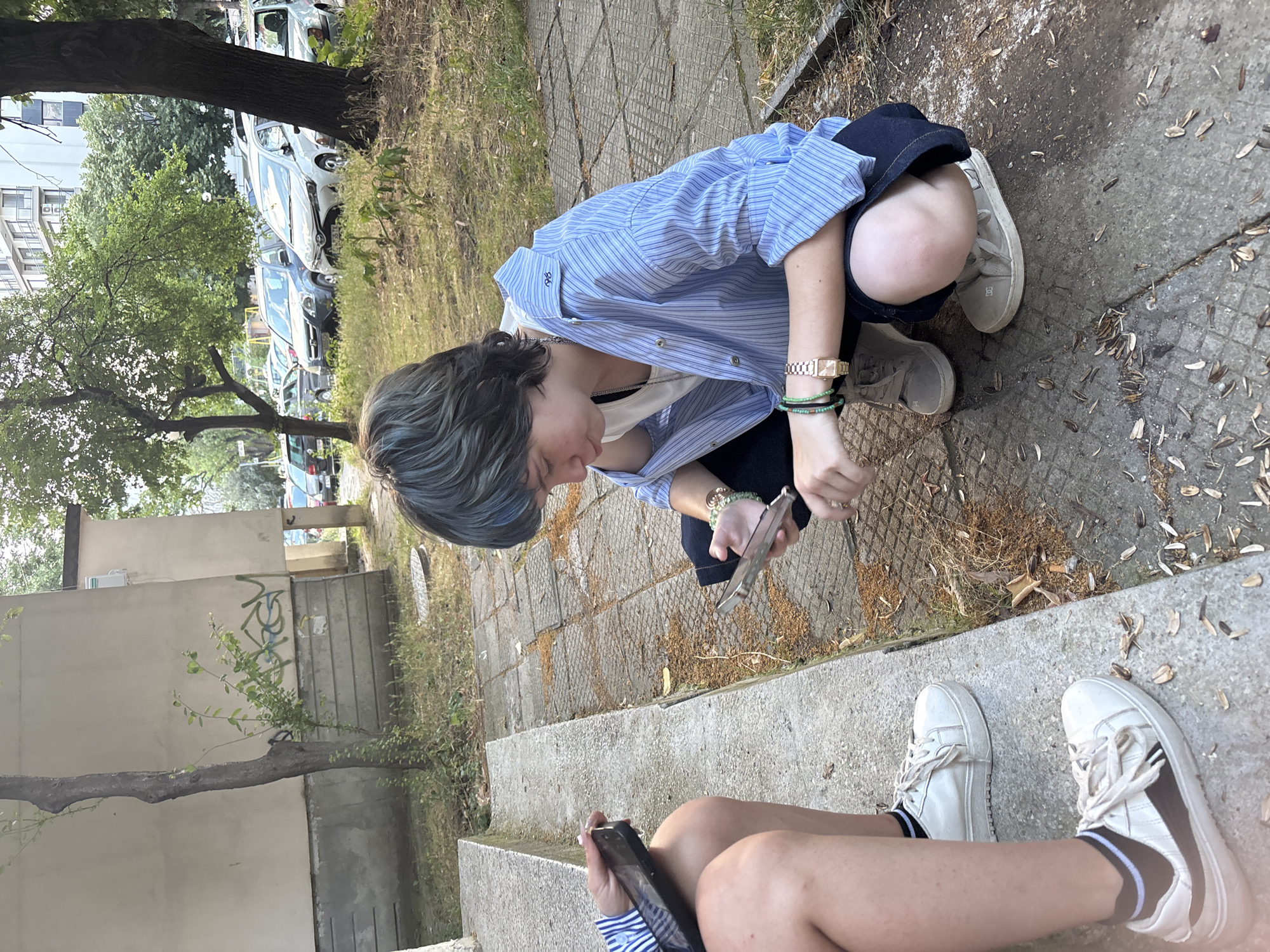 Crouched on pavement near concrete steps in Varna