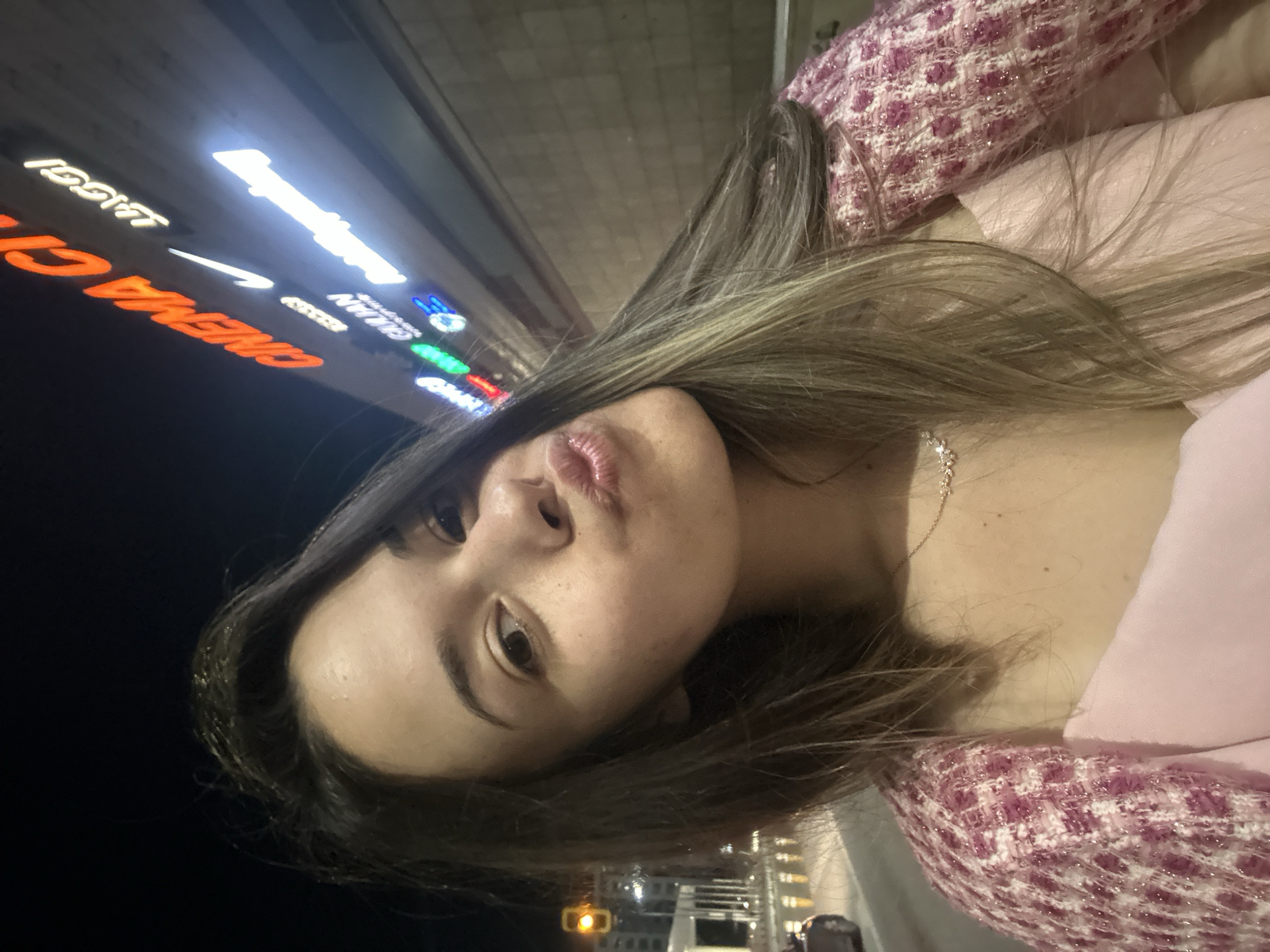 Woman takes nighttime selfies on Sofia streets near Paradise Center