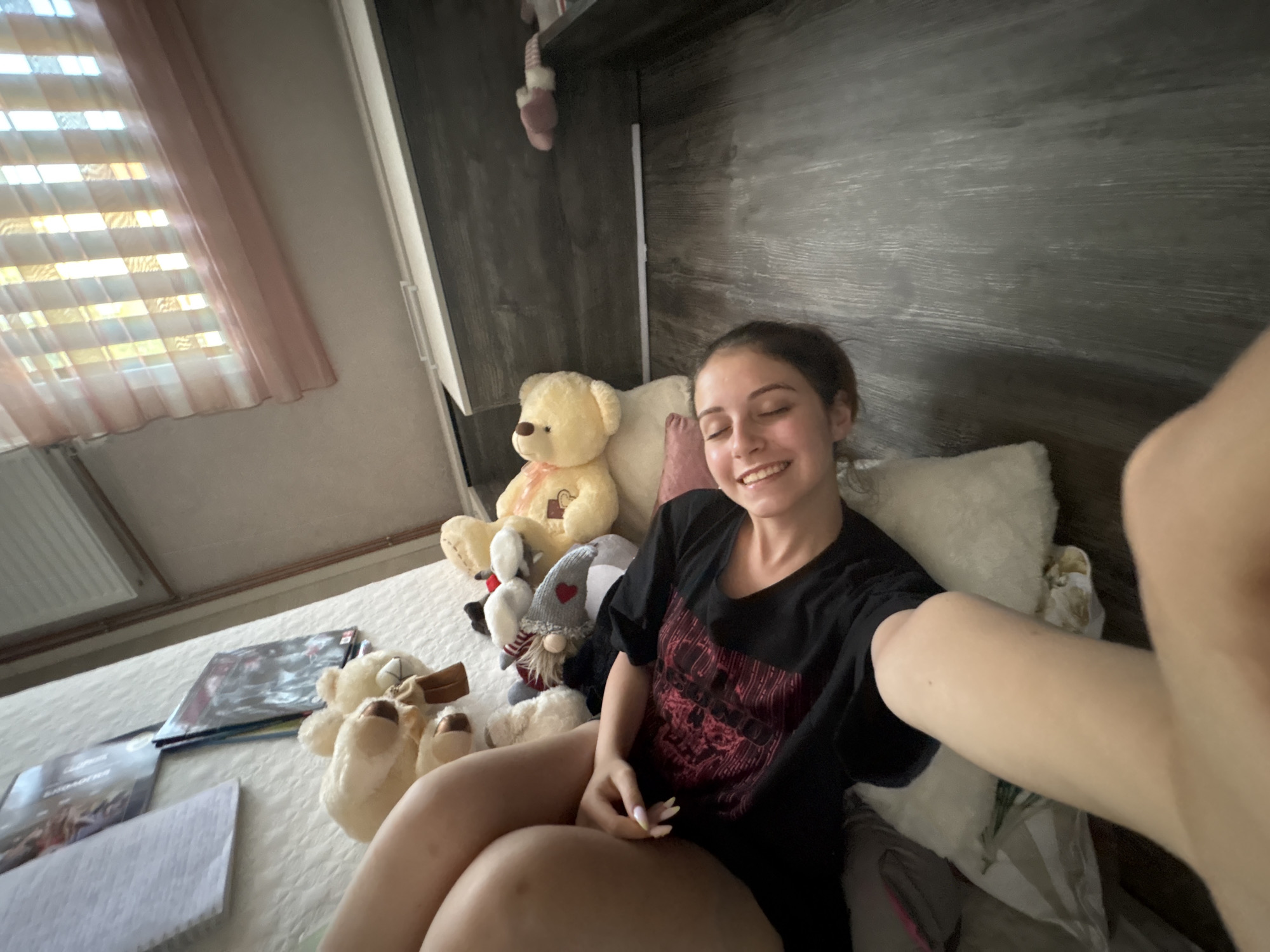 Woman Takes Relaxed Selfies on Bed in Bulgarovo