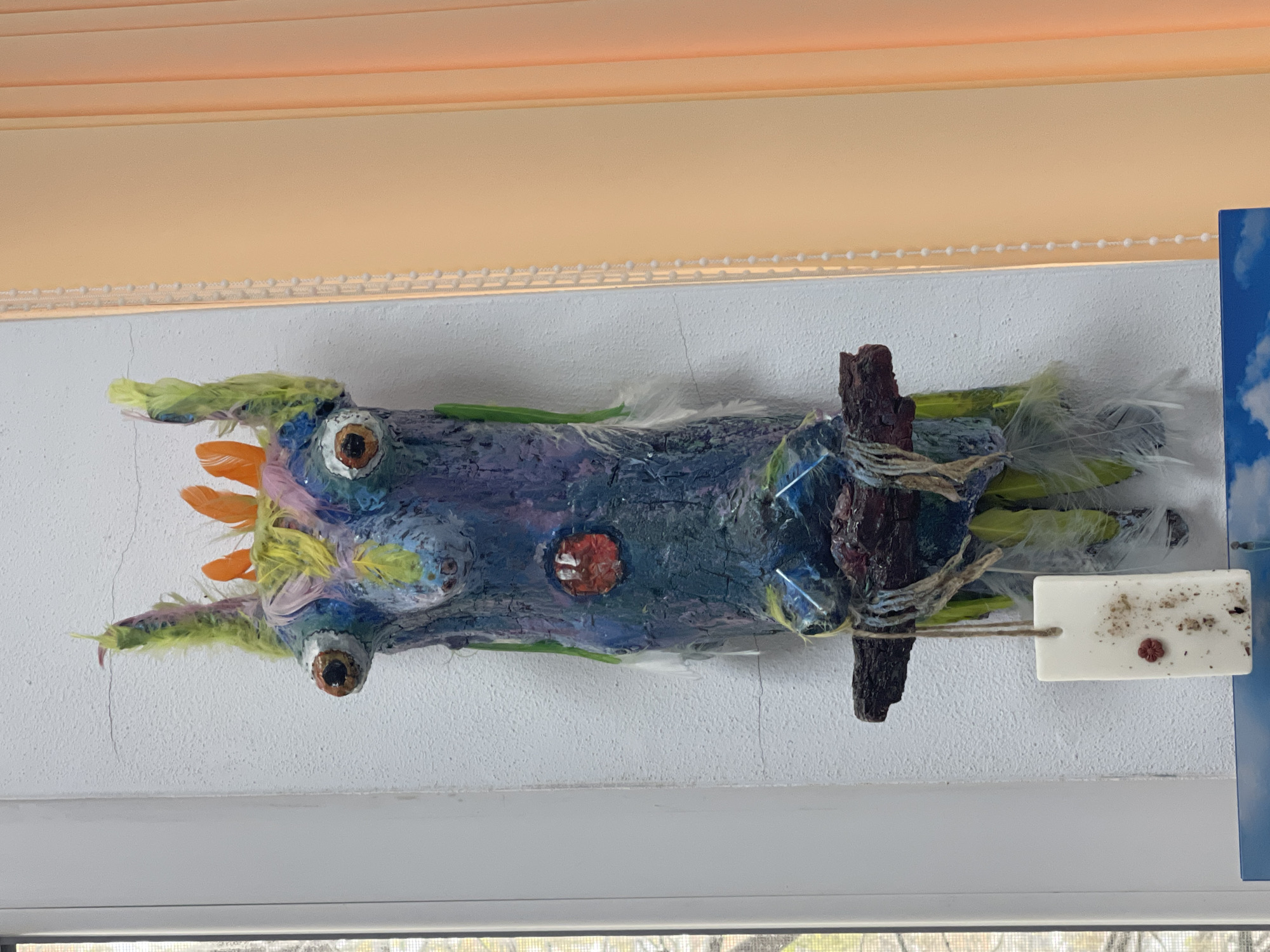 Colorful handcrafted driftwood art displayed on wall in Sevlievo