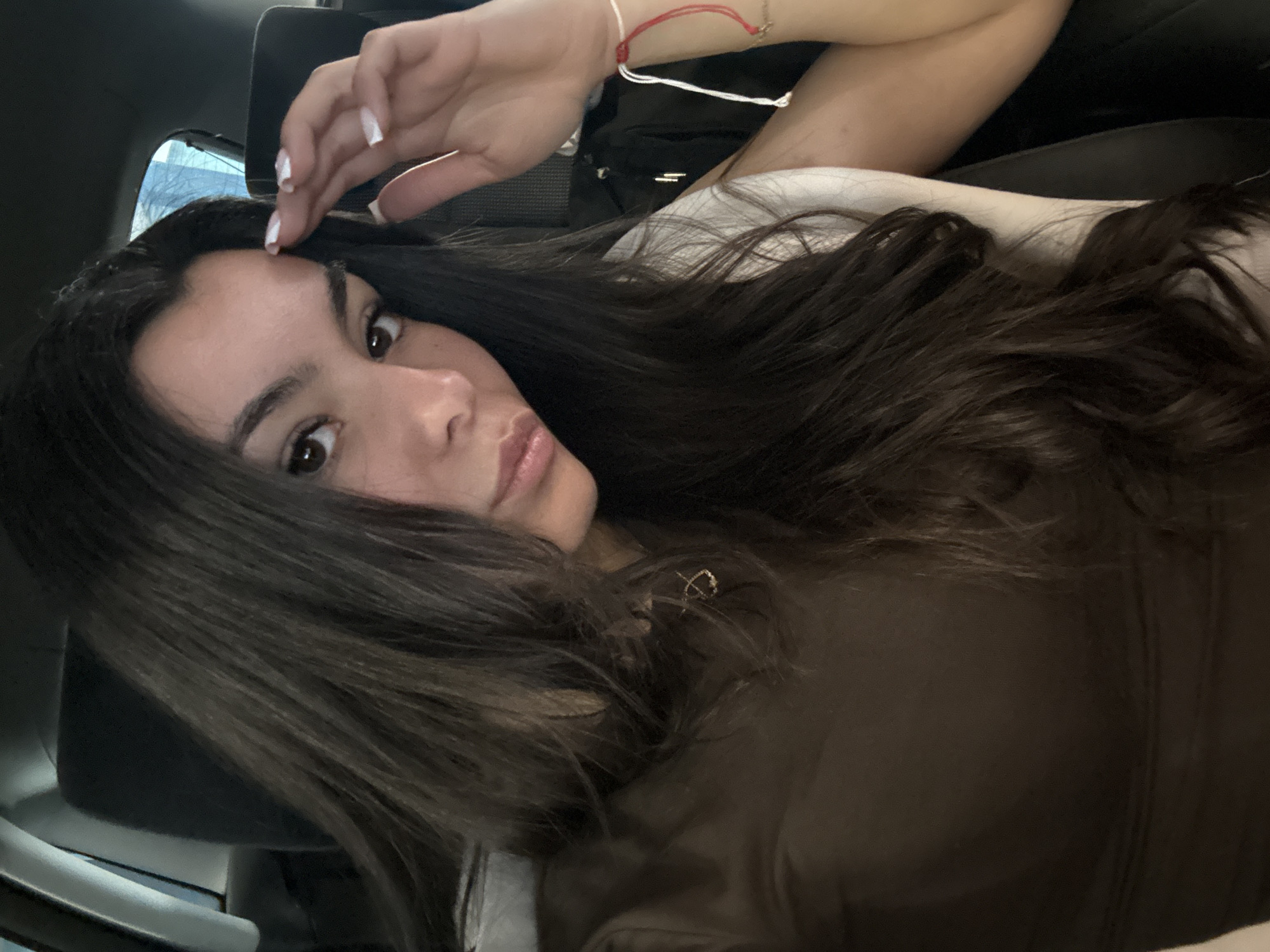 Woman takes selfies in car passenger seat in Varna