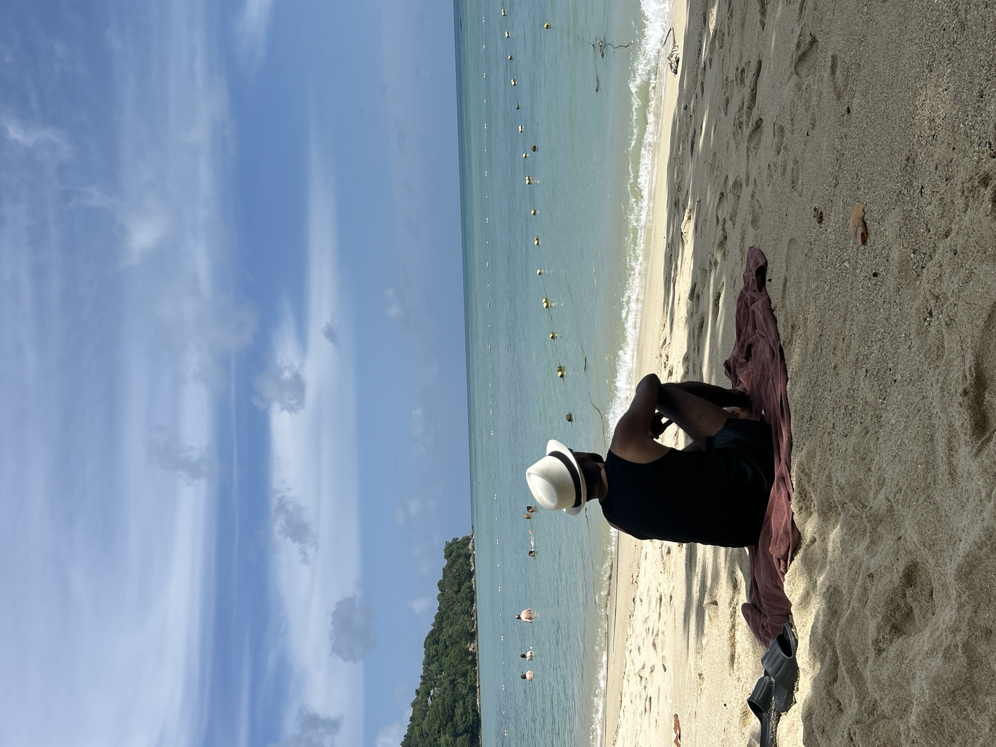 Quiet stretch of Patong beach and hillside path, early morning.