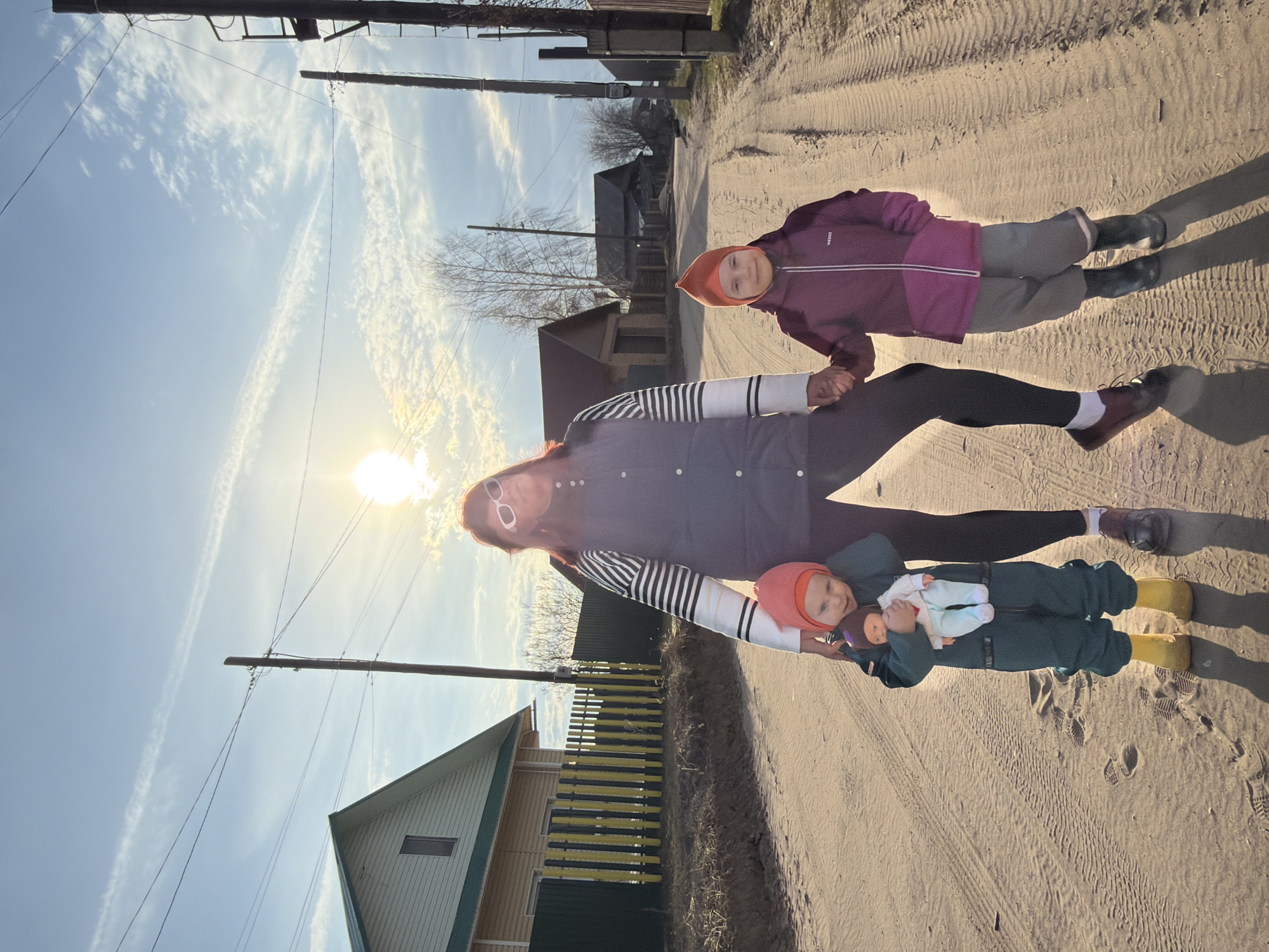Family walks dirt road in rural Chaikovsky, Russia