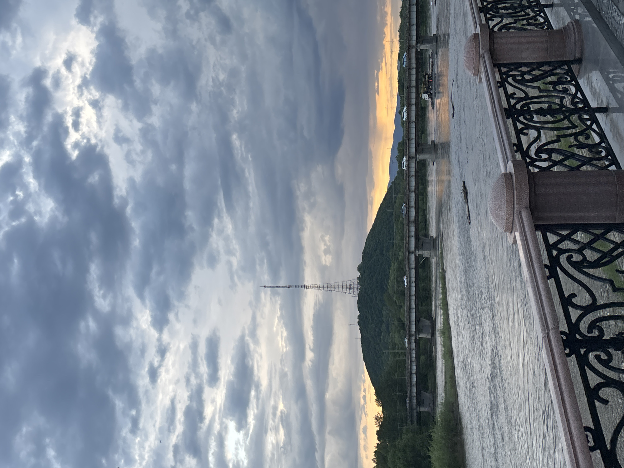 Morning scenes documented along riverside promenade with sculptures, pedestrians