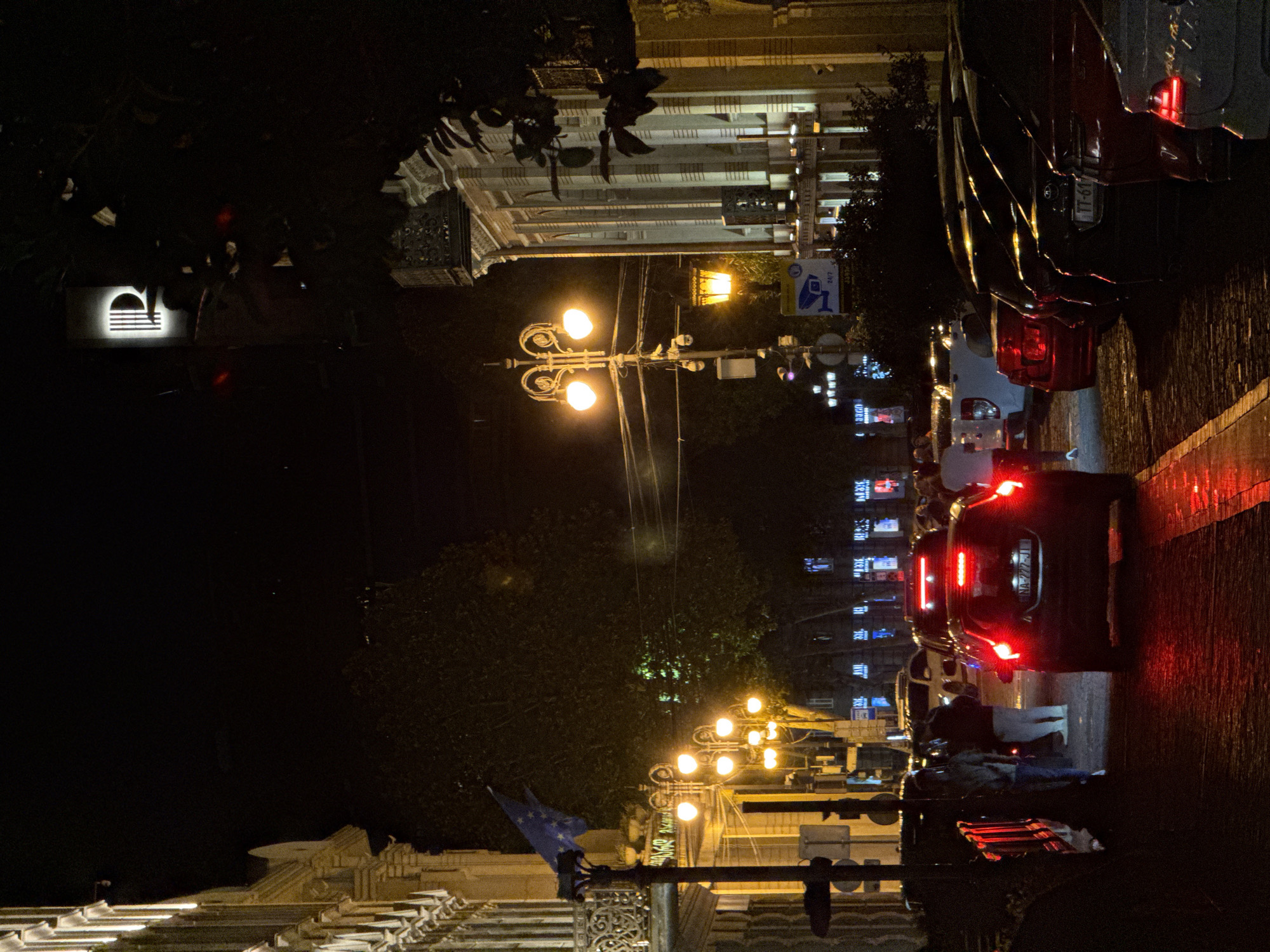 Rainy night in Tbilisi — wet streets and a well-stocked bar
