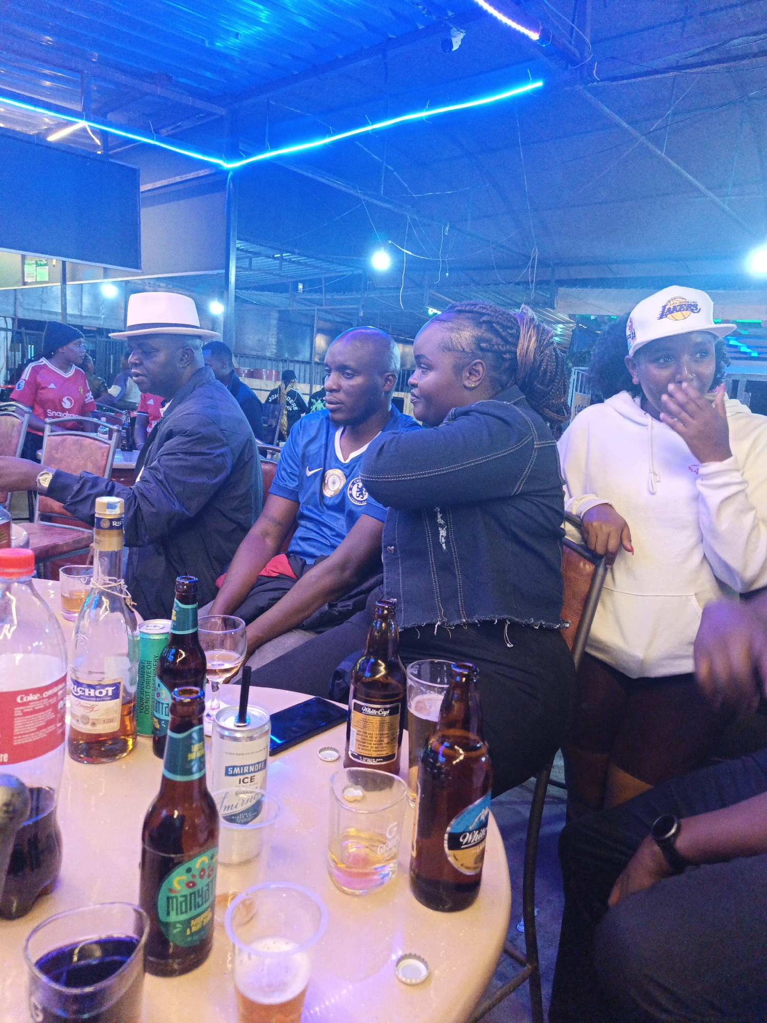 Group gathers at crowded table in Nairobi establishment