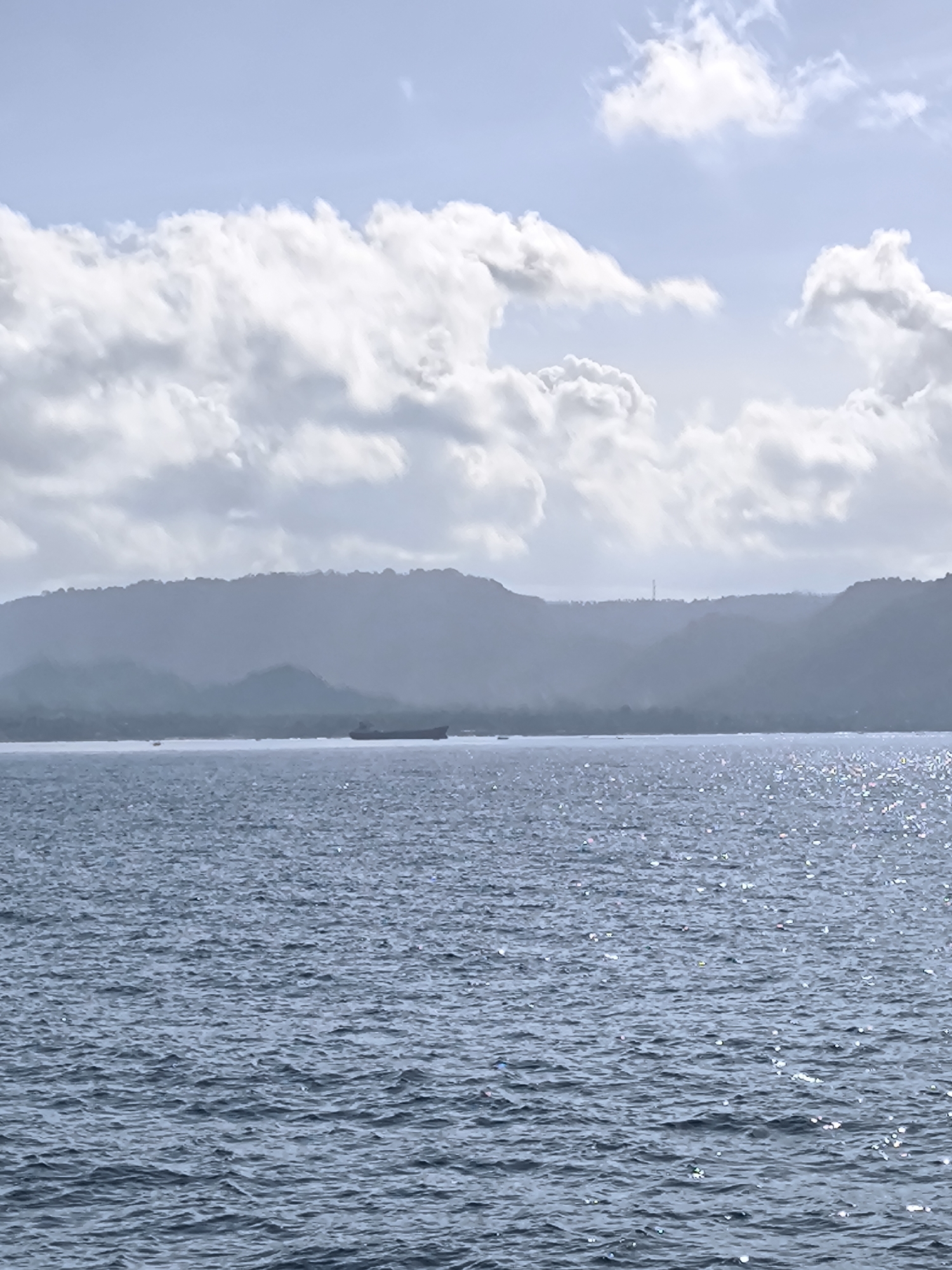 Boat passengers enjoy sunny morning journey off Indonesian coast