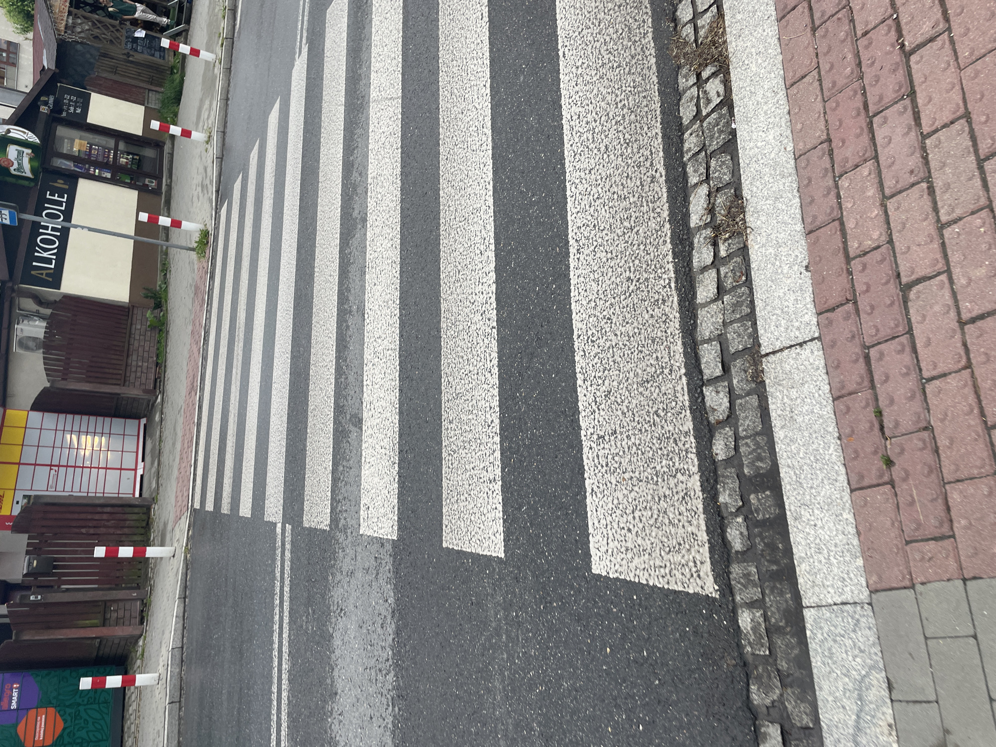 Overcast afternoon with wet streets documented across Kraków