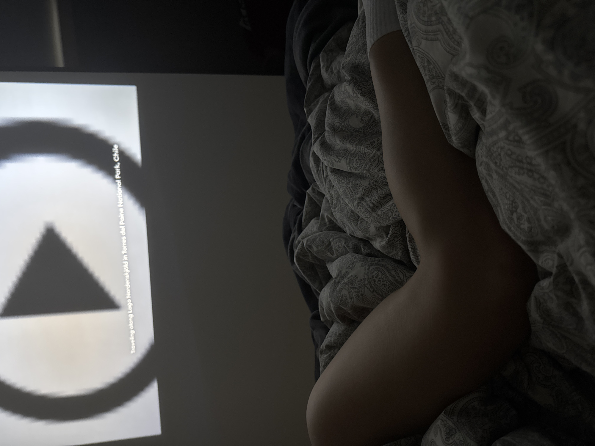 Person watches geometric video content in bed Monday evening
