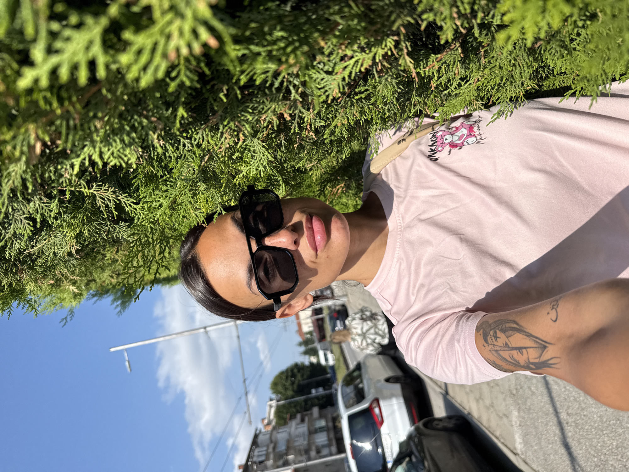 Outdoor selfie beside a green hedge in Pleven, Bulgaria