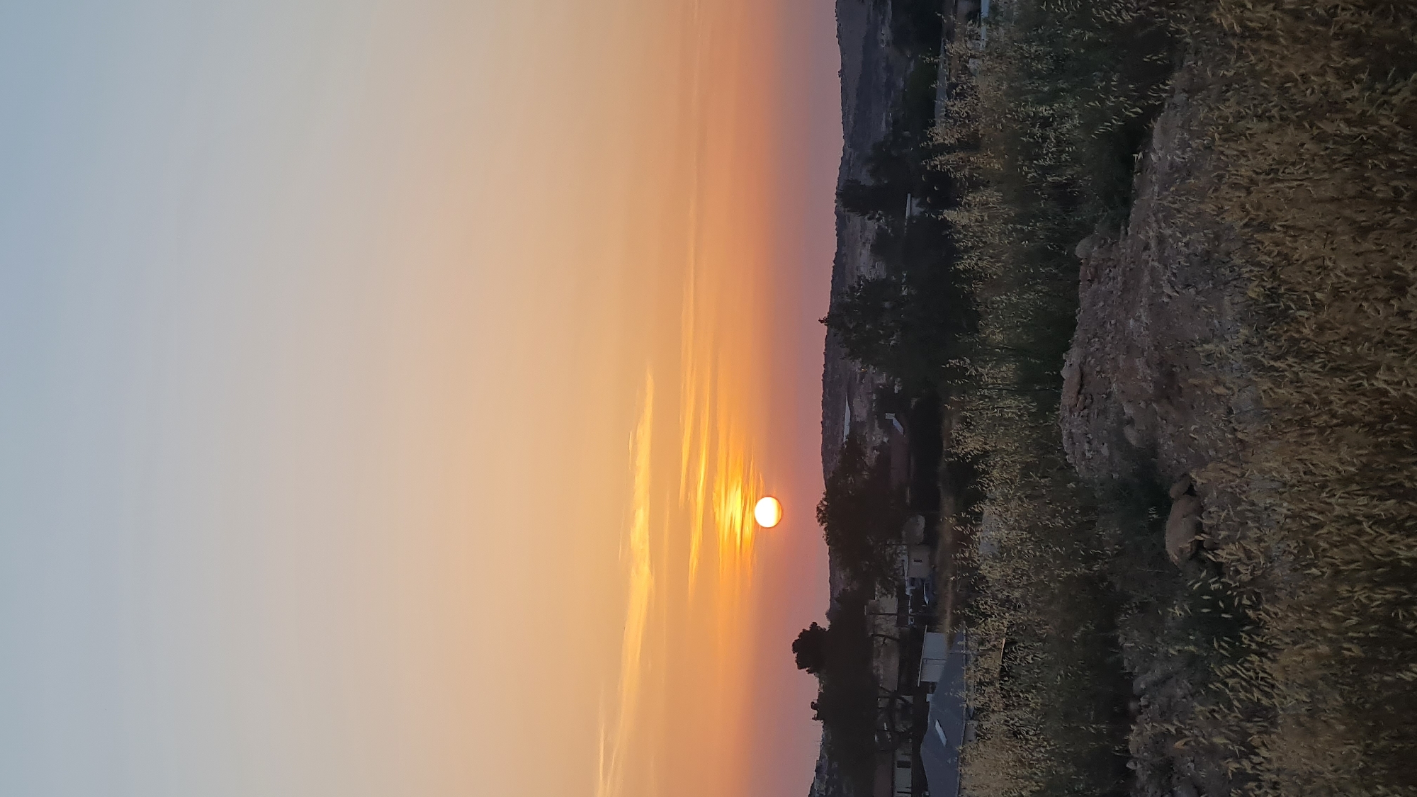 Sunset sequence documented over rural Israel agricultural landscape