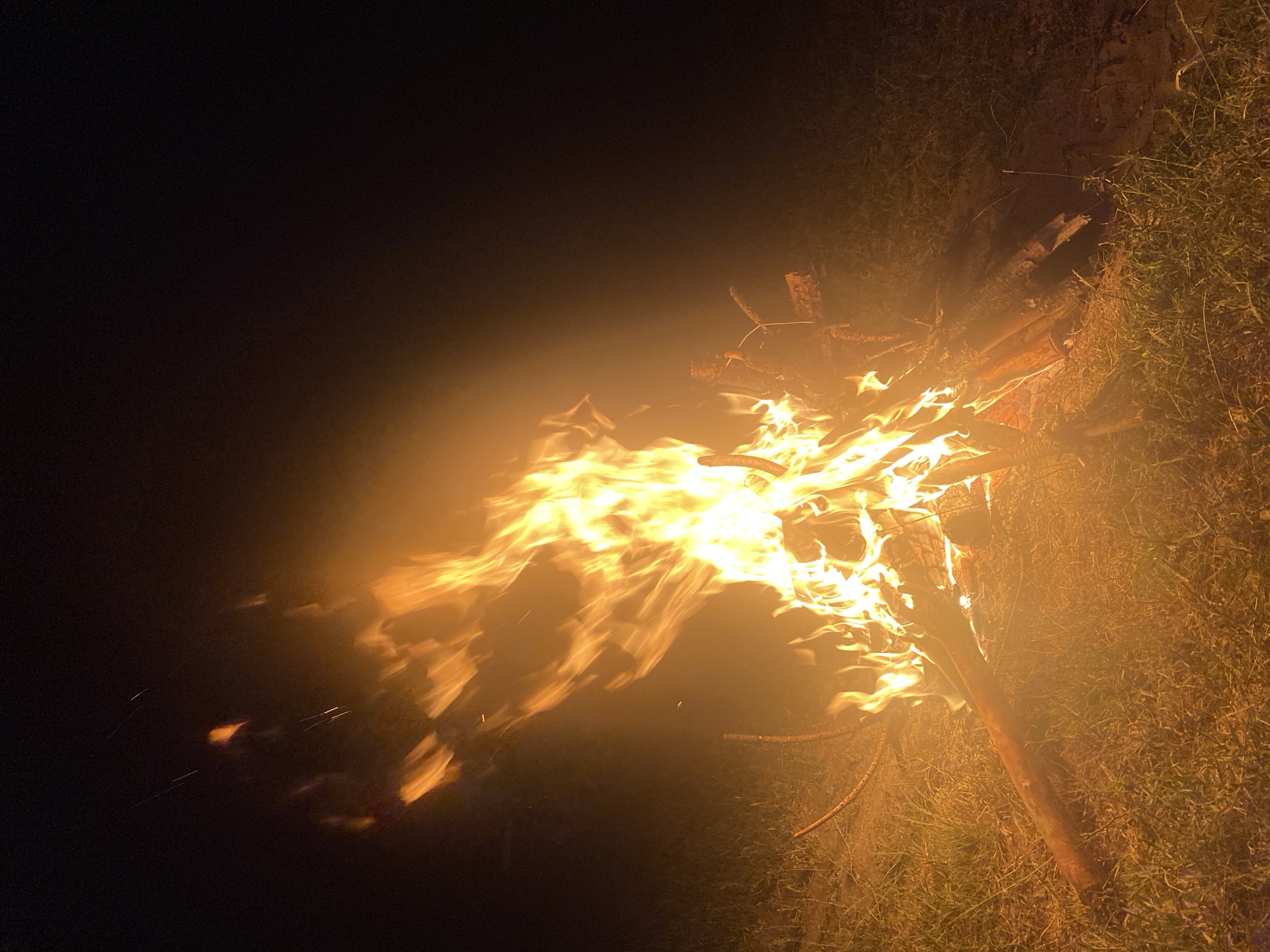 Bonfire burns under a full moon near Batak, Bulgaria