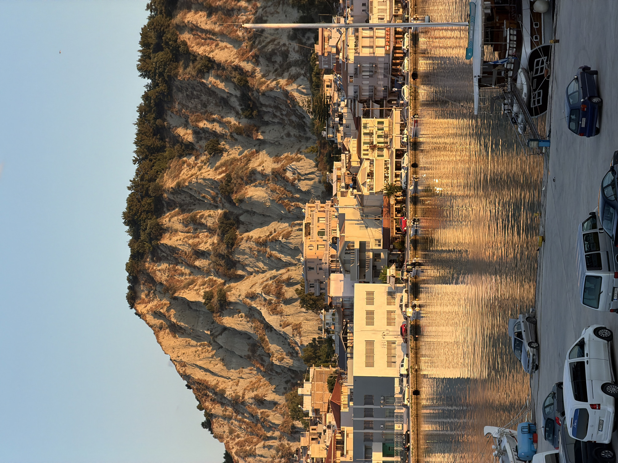 Zakynthos harbor at golden hour, port life in full swing