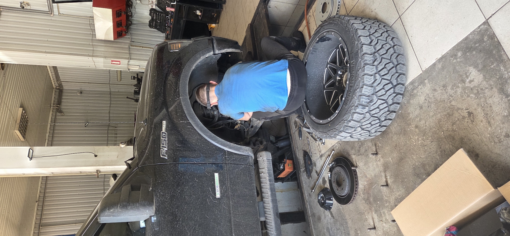Auto service activity across a Donetsk vehicle repair strip