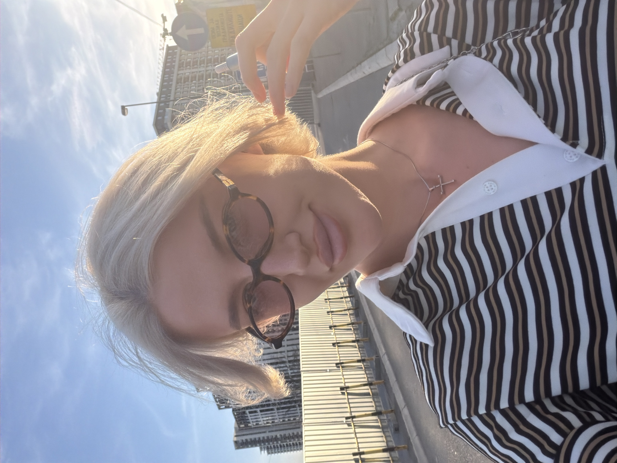 Woman takes selfies on sunny afternoon in Belgrade