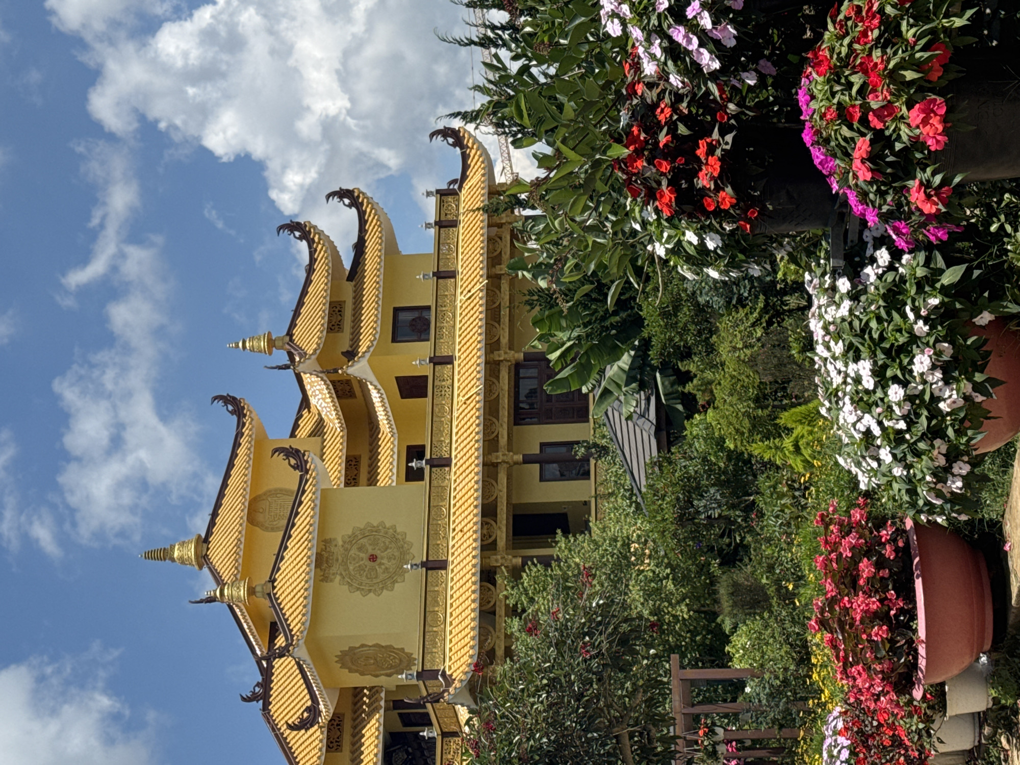 Golden tiered building with traditional architecture observed in Da Lat