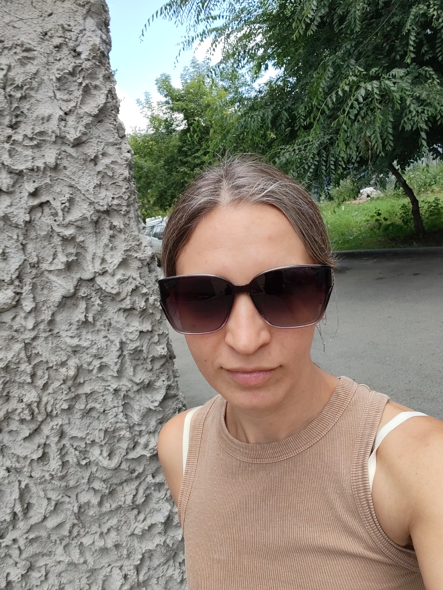 Selfies and street crossings at a brick building exterior