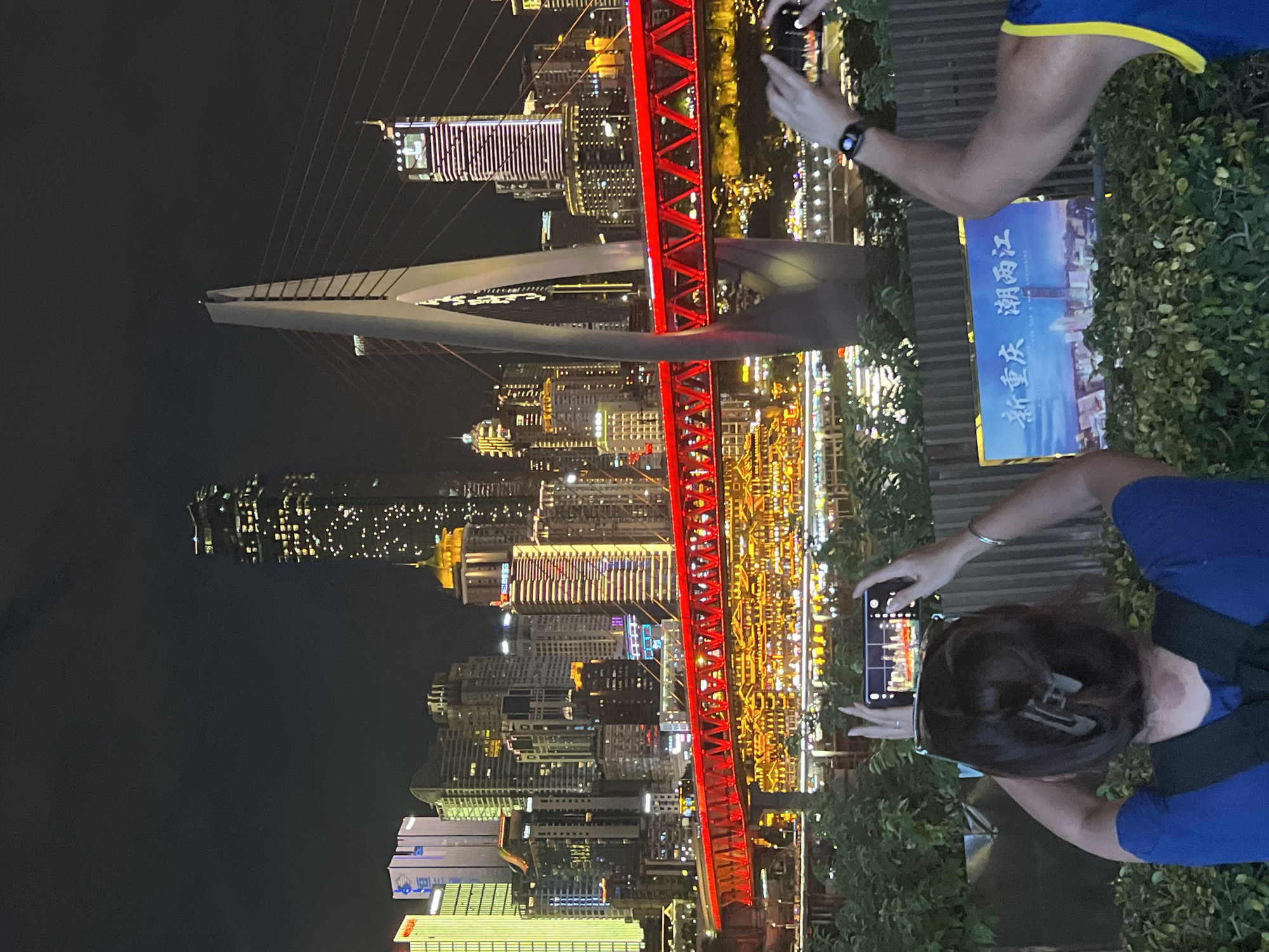 Chongqing's Jiangbeicheng skyline and red bridge lit up at night
