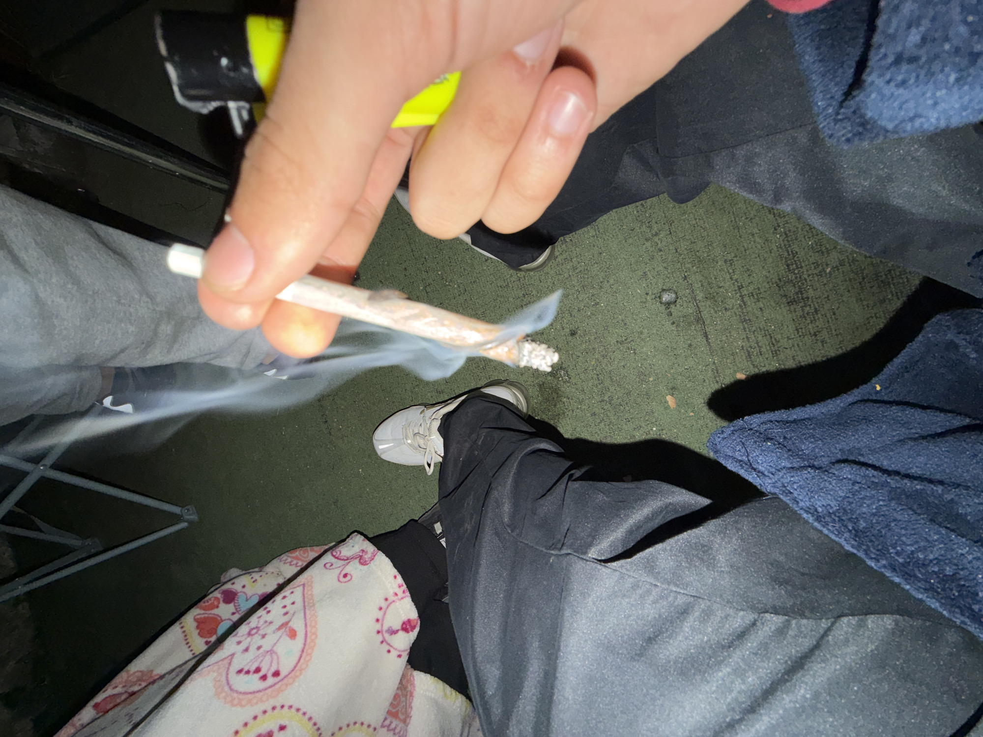 Person smoking rolled cigarette indoors in Vila Real
