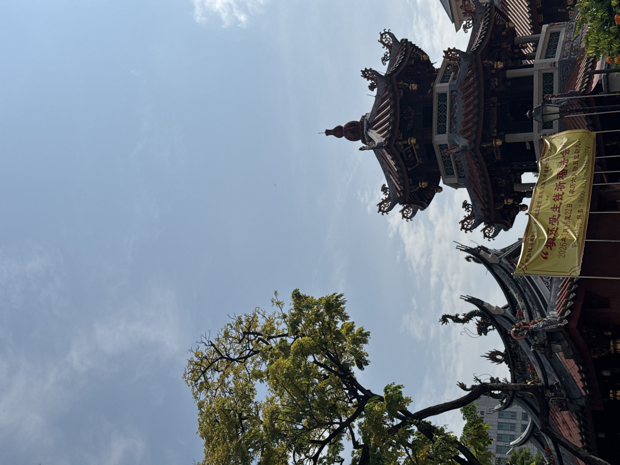 Temple rooflines and a parked G-Wagon in Singapore's heritage district