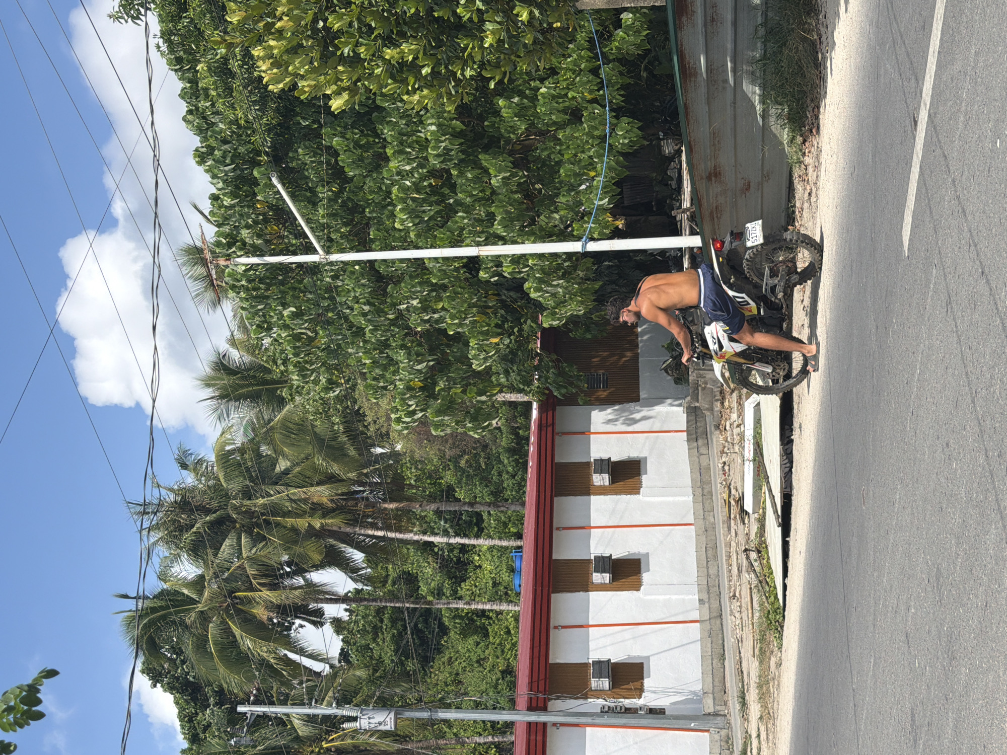 Man performs motorcycle wheelie on General Luna street