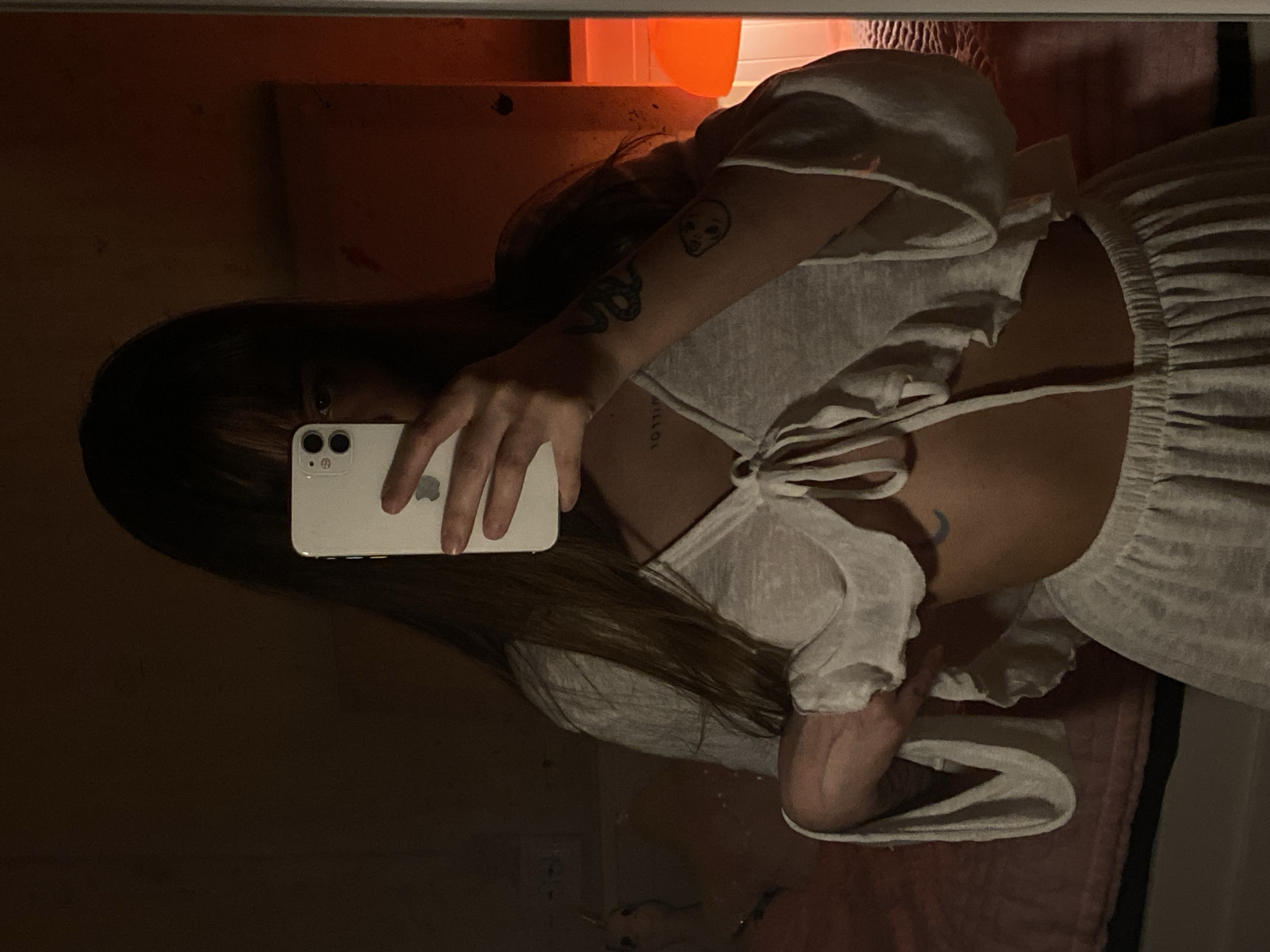 Person takes selfies with white phone in Votkinsk apartment
